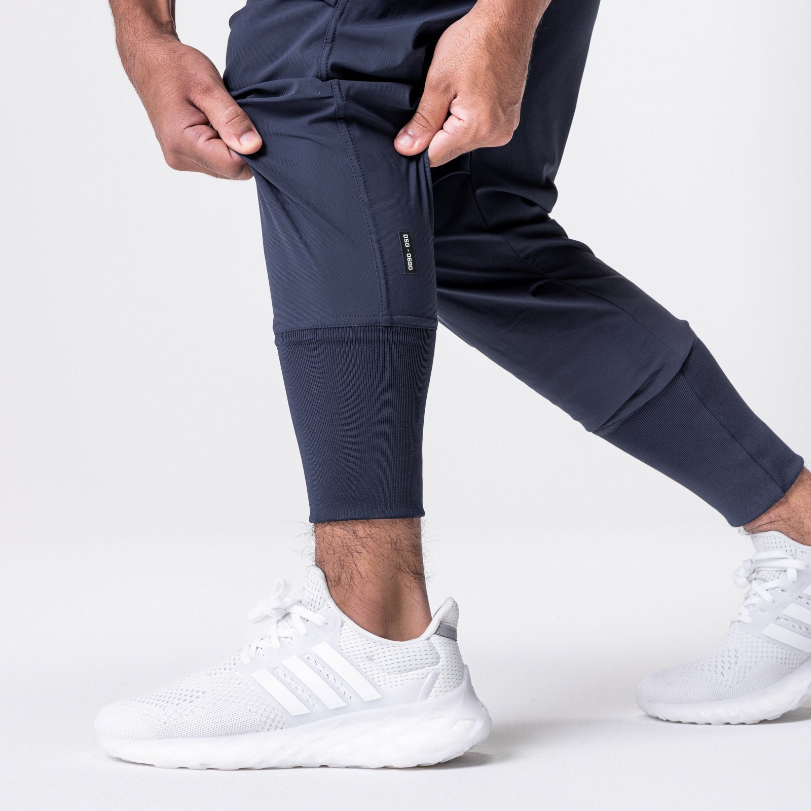 Tetra-Lite Tech High Rib Jogger in navy worn by model, lower body view with white sneakers