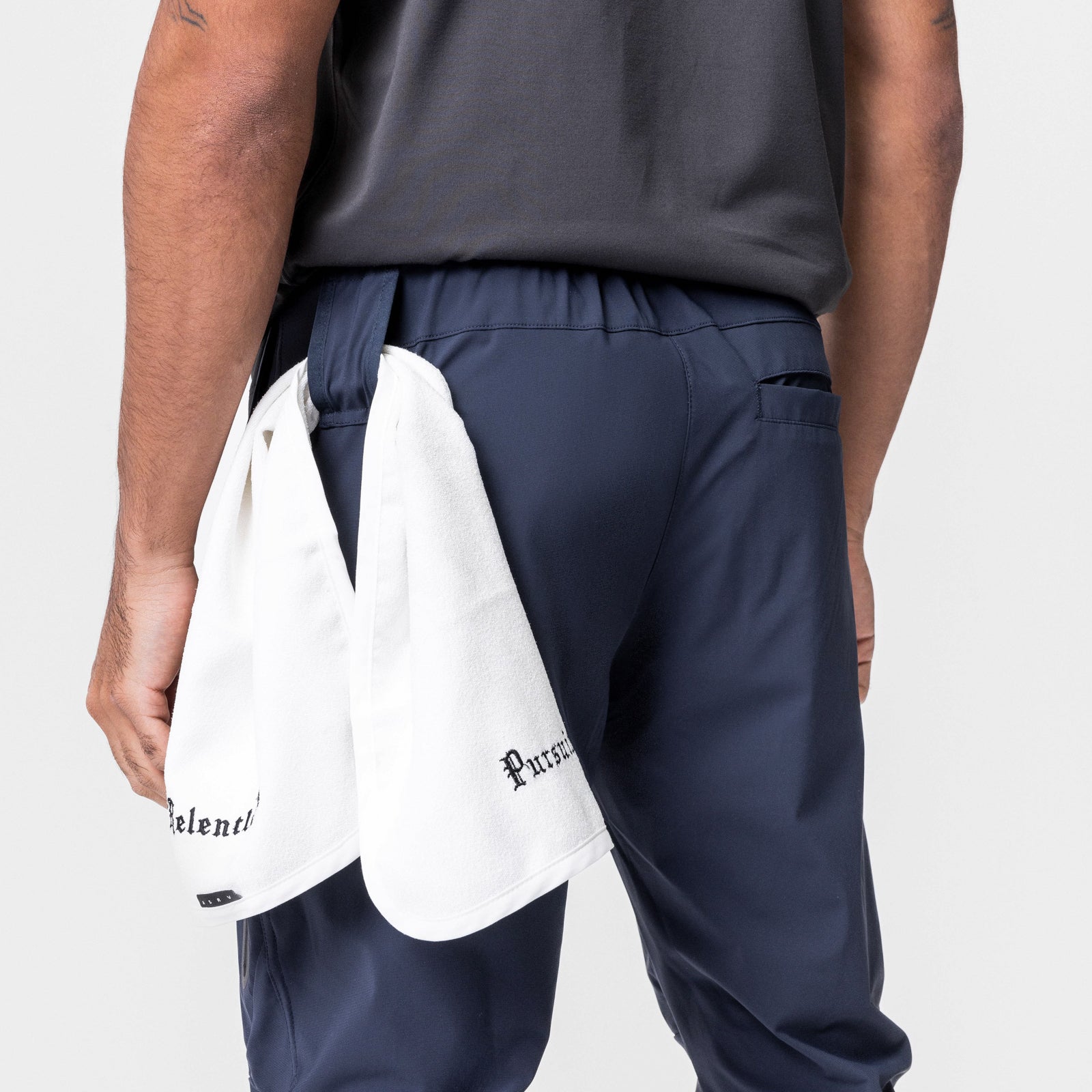 Tetra-Lite® Tech High Rib Jogger in navy worn by model, back view with white towel