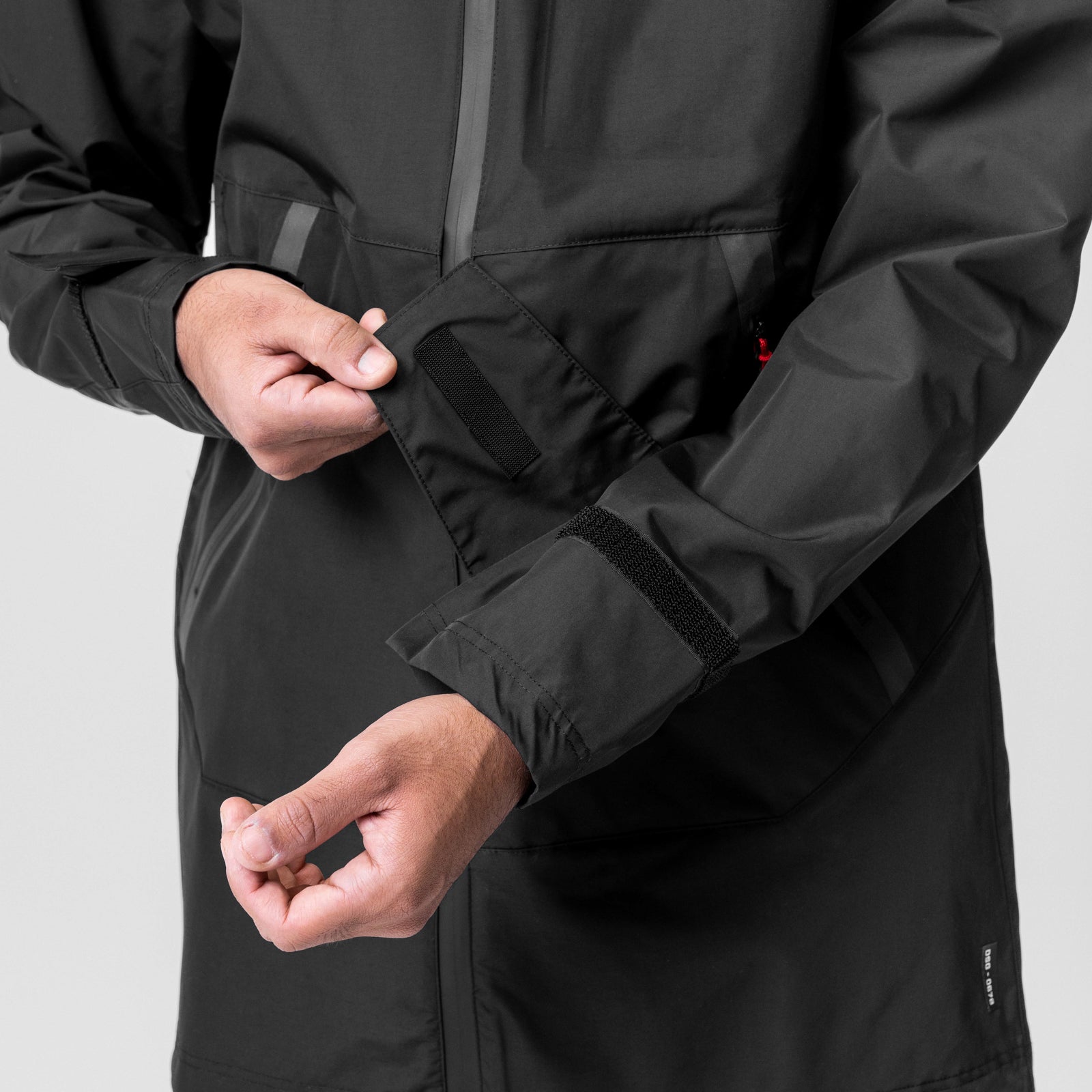 Black Hipora® Tech Parka worn by model, showing adjustable cuff detail and front view