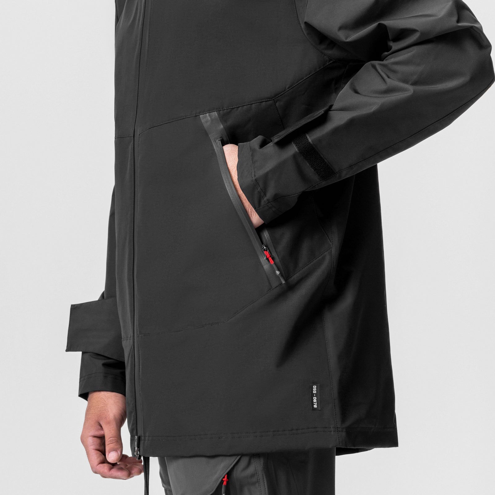 Black Hipora® Tech Parka worn by model, side view showing hand pocket and sleeve detail