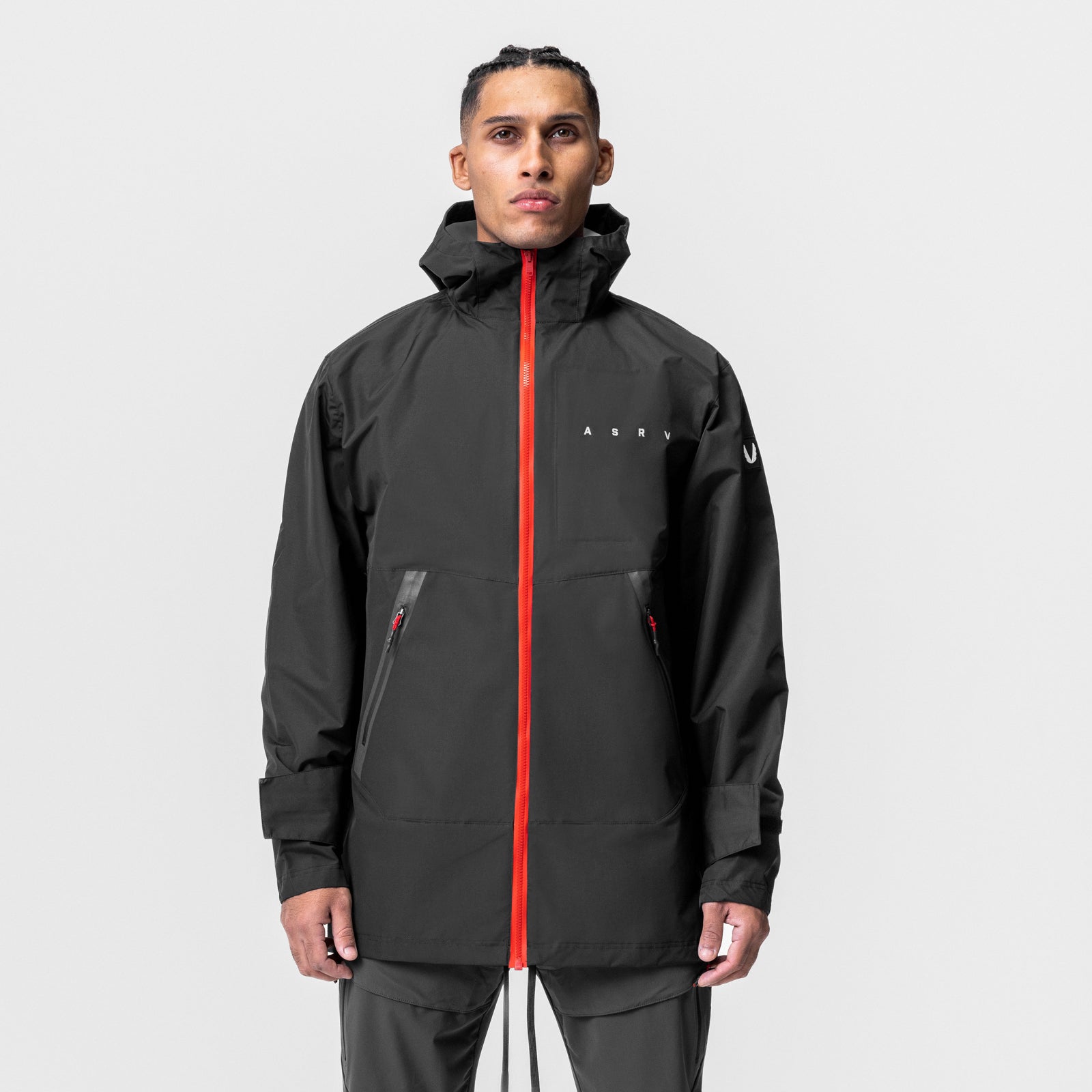 Hipora AQUAzip Tech Parka in black worn by model, front view with red zip