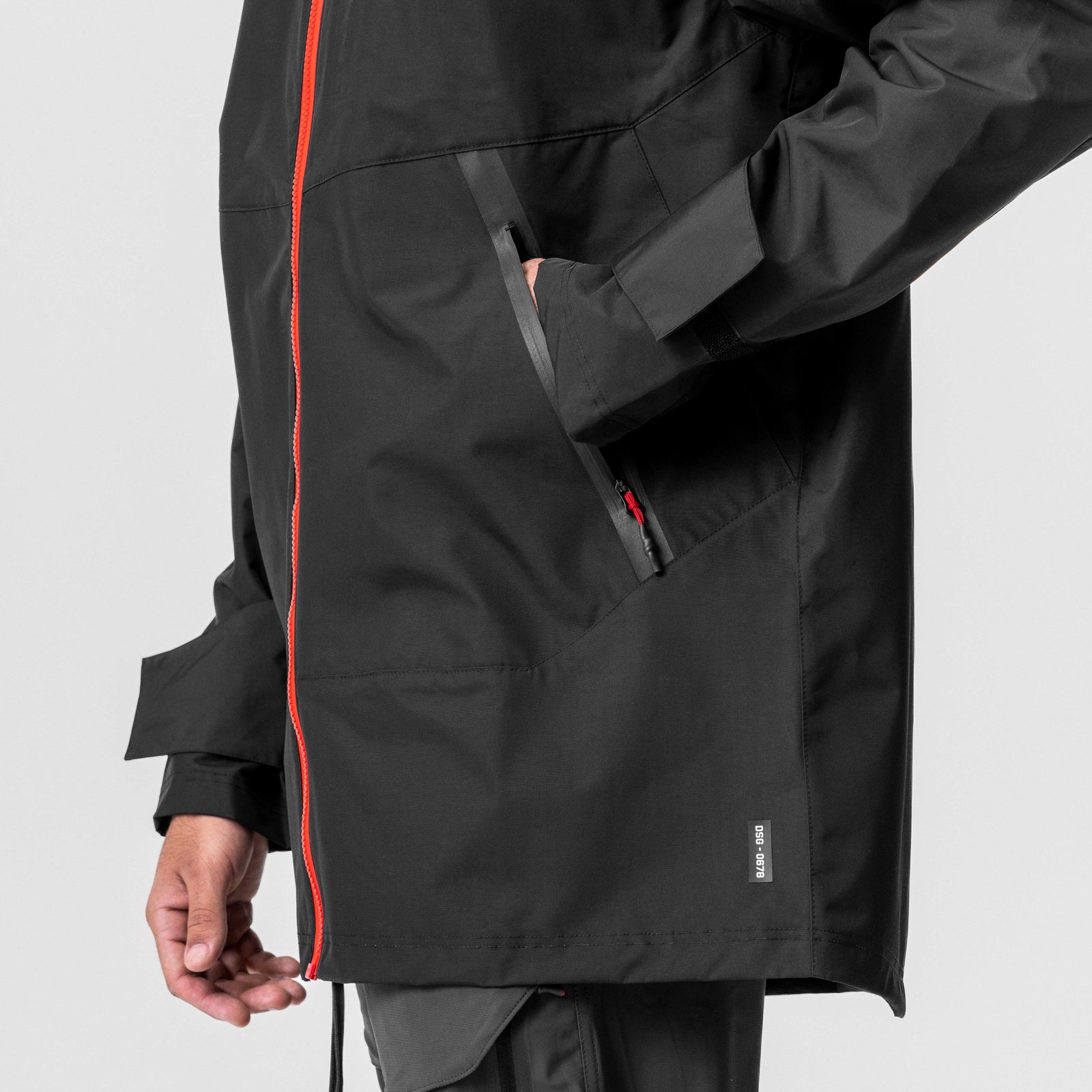 Black Hipora AQUAzip Tech Parka worn by model, side view showing zipper detail