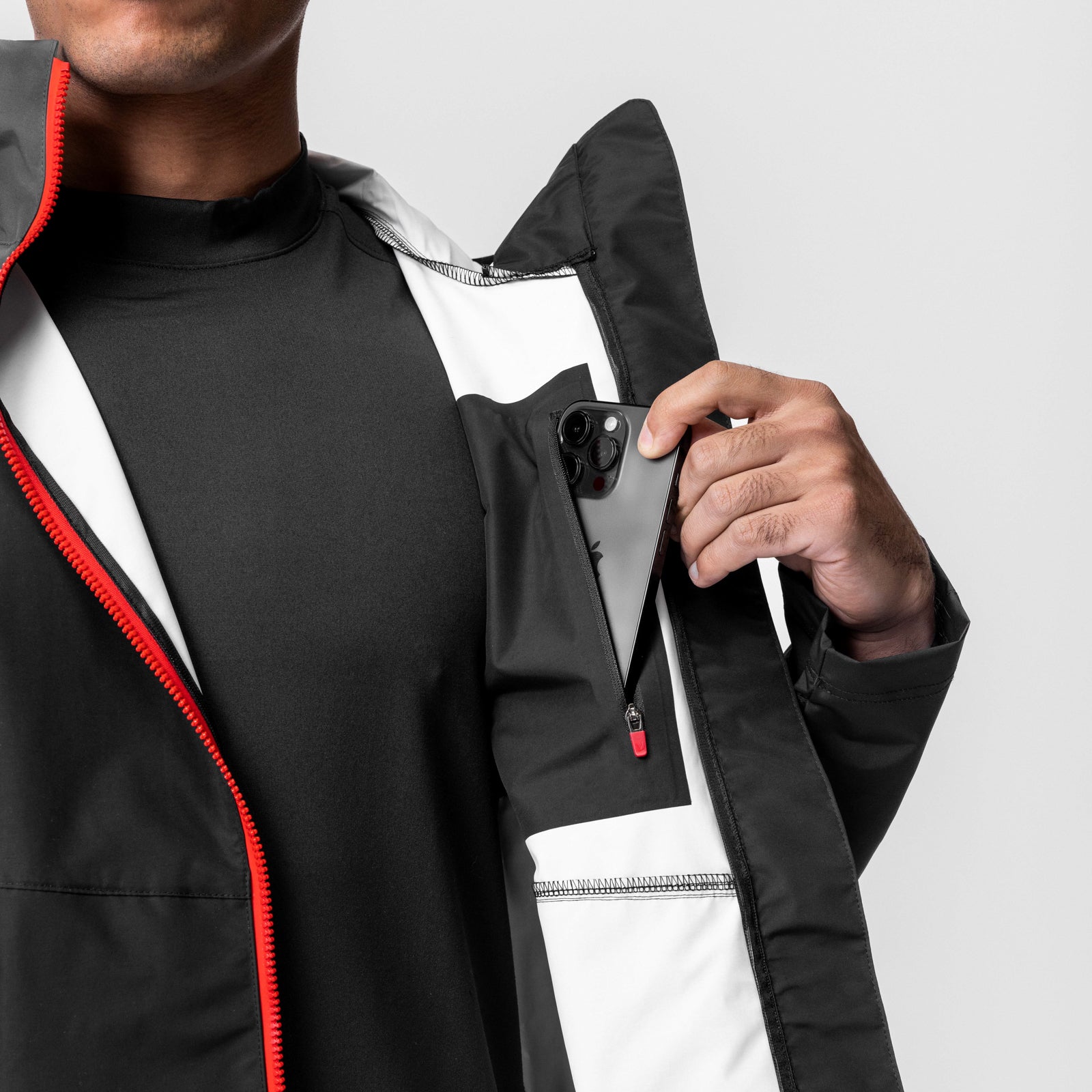 Hipora AQUAzip Tech Parka in black, model wearing jacket with internal pocket detail visible