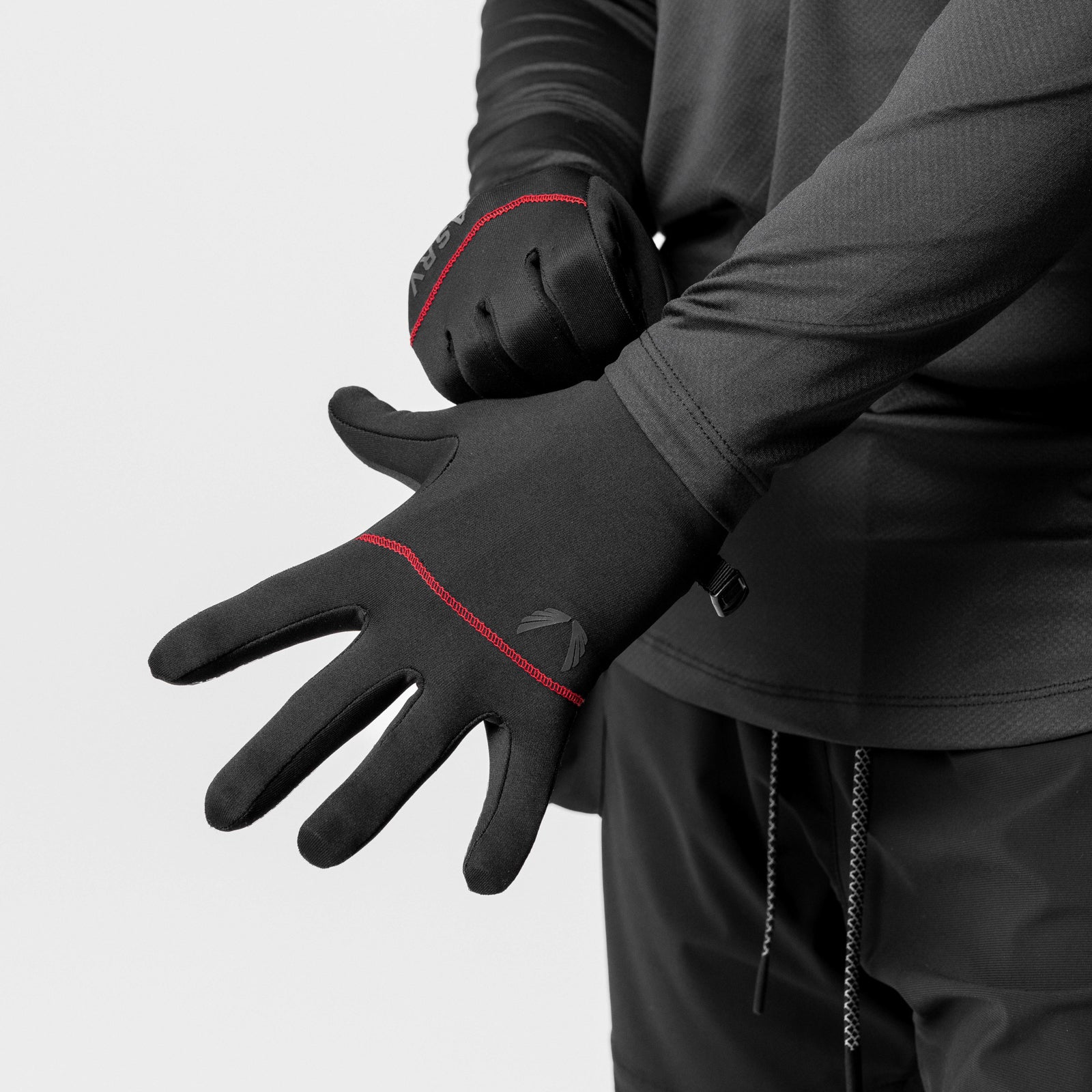 Aeroheat® Lightweight Gloves in black with red trim, worn on model's hands