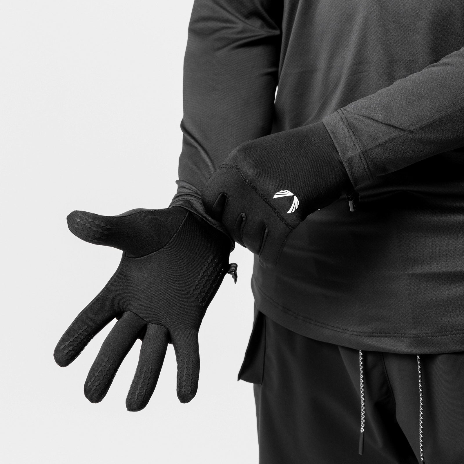 Aeroheat® Lightweight Gloves in black with white logo detail, worn on model's hand