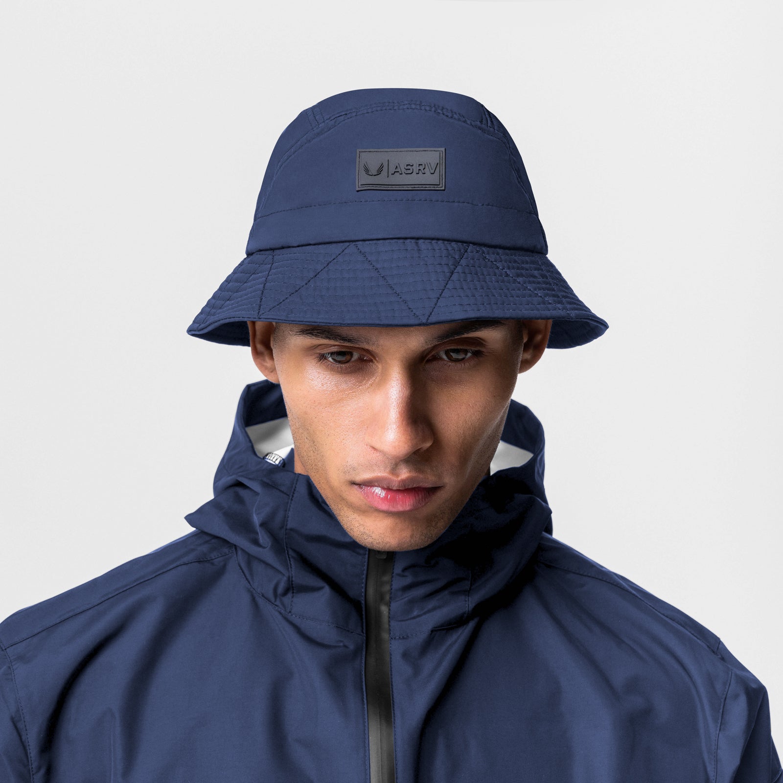 0672 Hipora® Bucket Hat in Navy with Patch Logo, worn by model, front view
