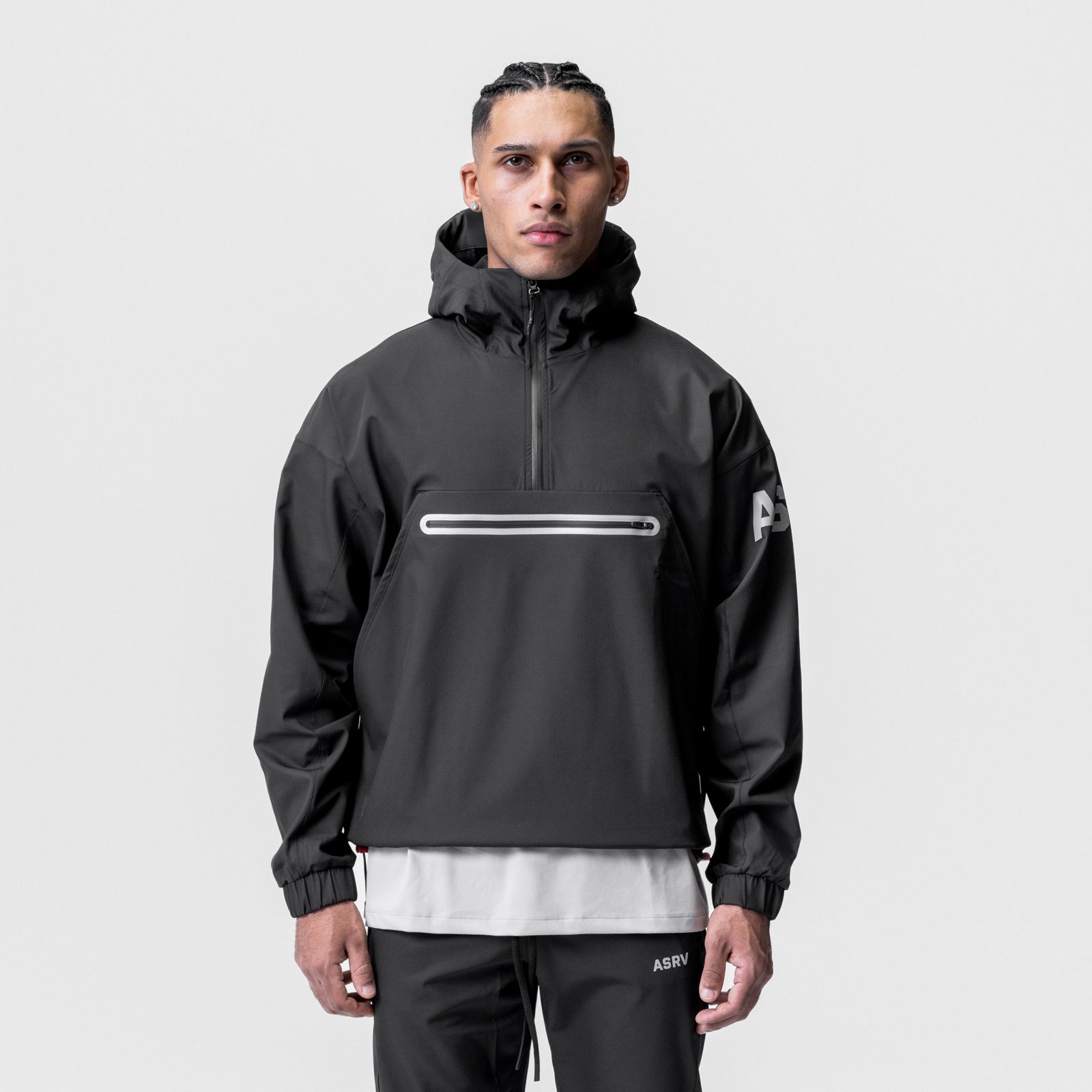 Black weather-ready anorak jacket worn by model, front view with hood up