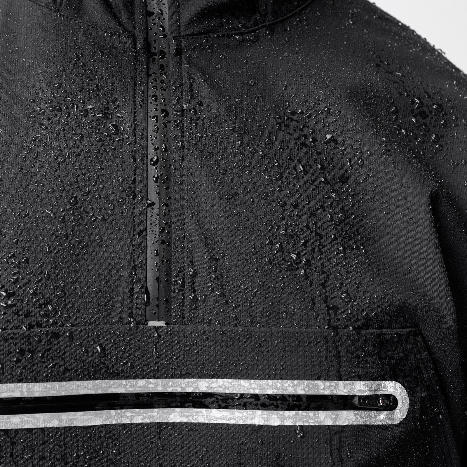 Weather-Ready Anorak Jacket in black worn by model, detail shot showing water-resistant fabric and reflective stripe