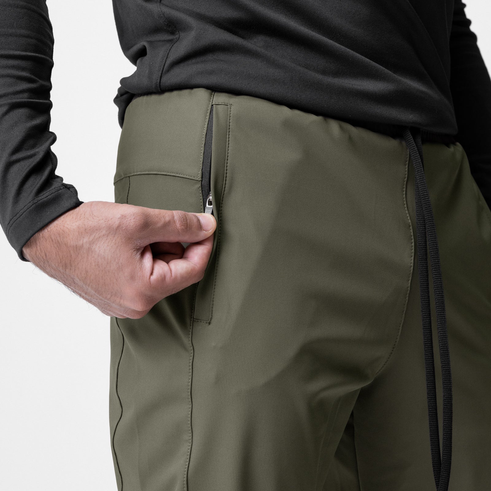 All Condition Moto Jogger in olive, worn by model showing side zip detail