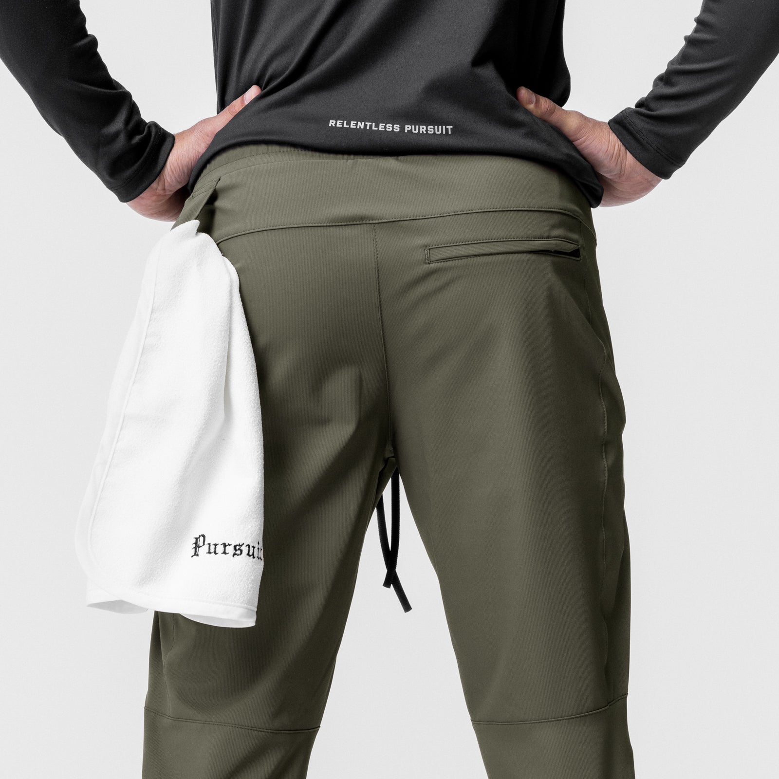 All Condition Moto Jogger in olive worn by model, back view with white towel