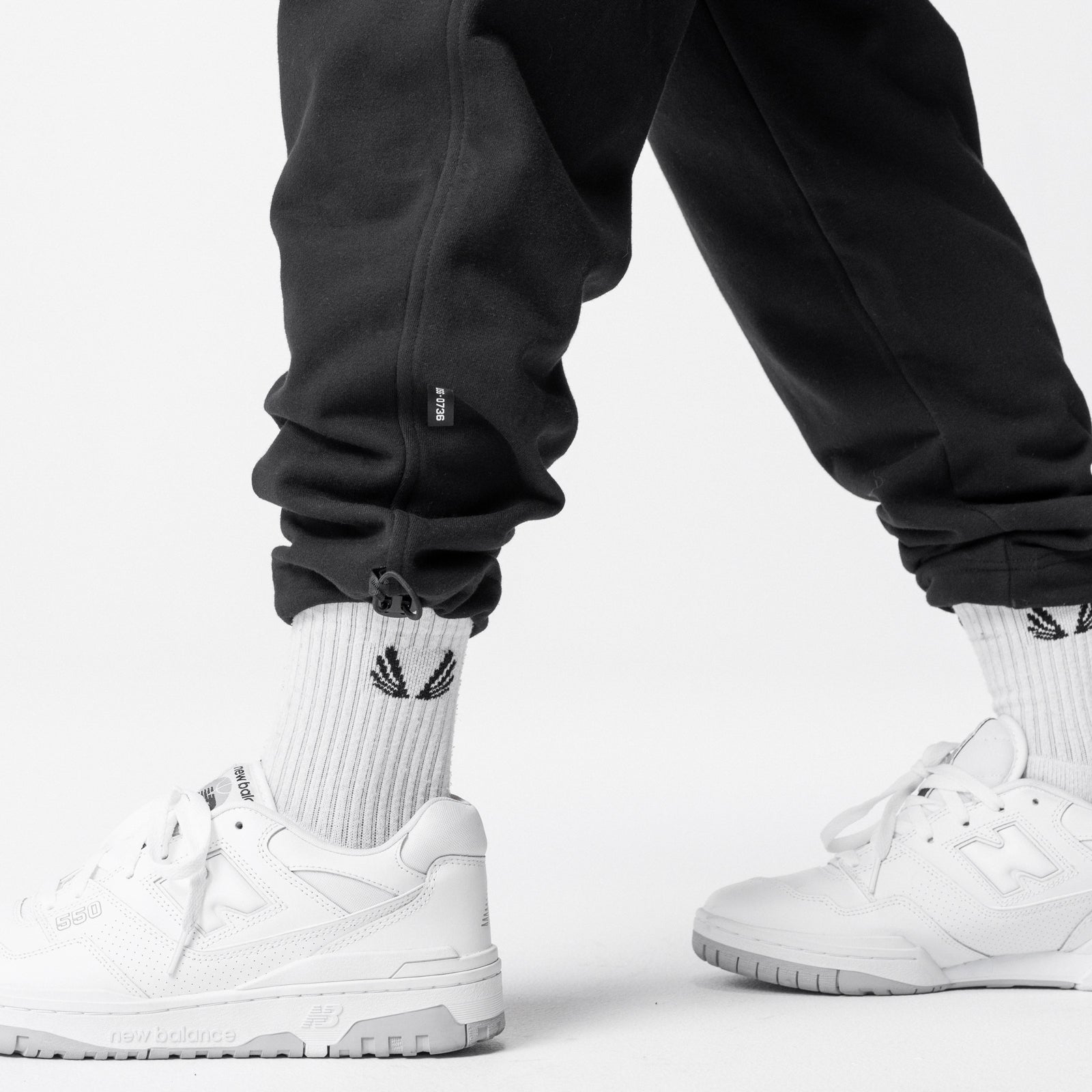 Black Tech-Terry Cinch Cargo Jogger worn with white socks and sneakers, styled shot