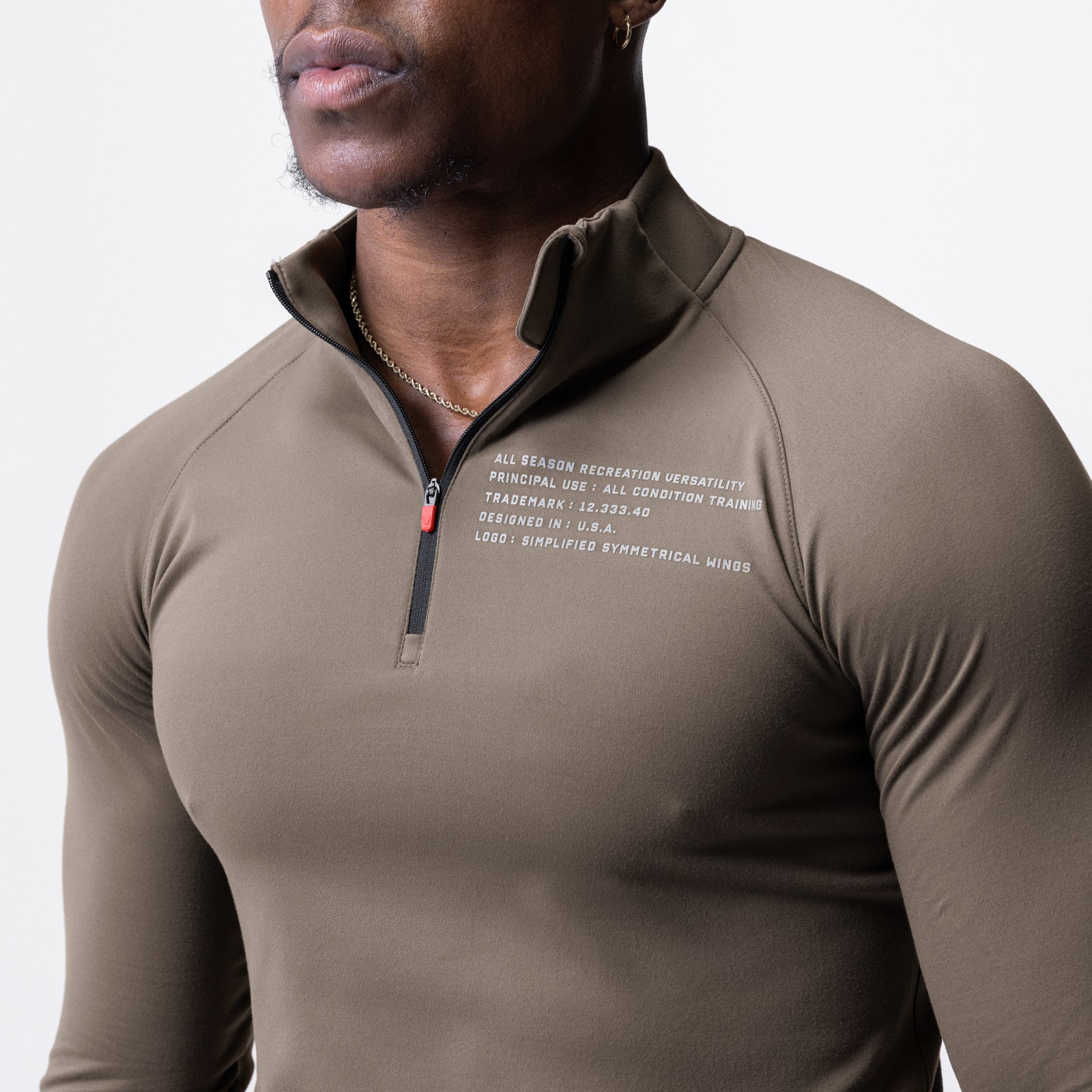 Core Fitted Quarter Zip in deep taupe worn by model, front view showing chest text details