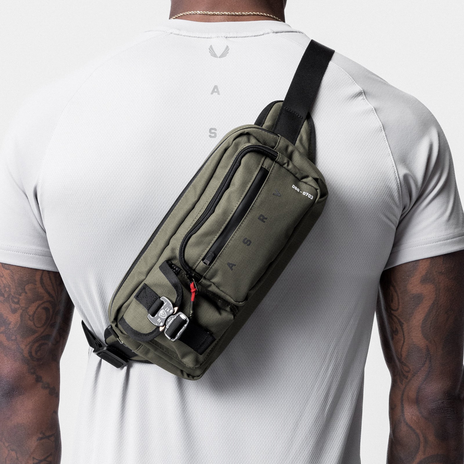 0703. Cordura® Tech Crossbody Pack in Olive, worn across back on model
