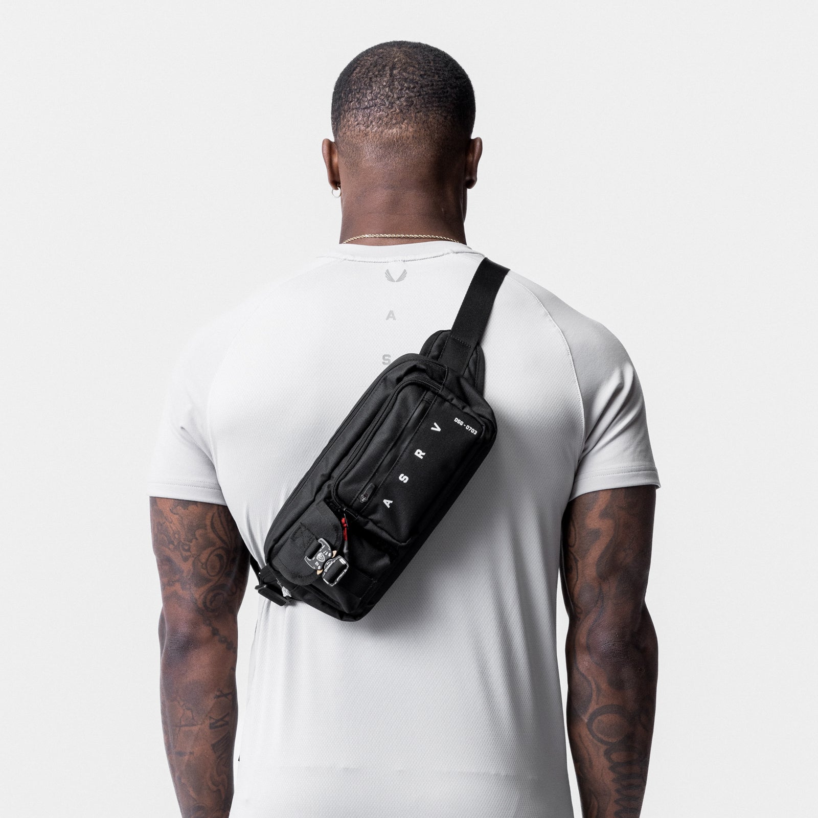 0703. Cordura® Tech Crossbody Pack in black, worn across chest, back view
