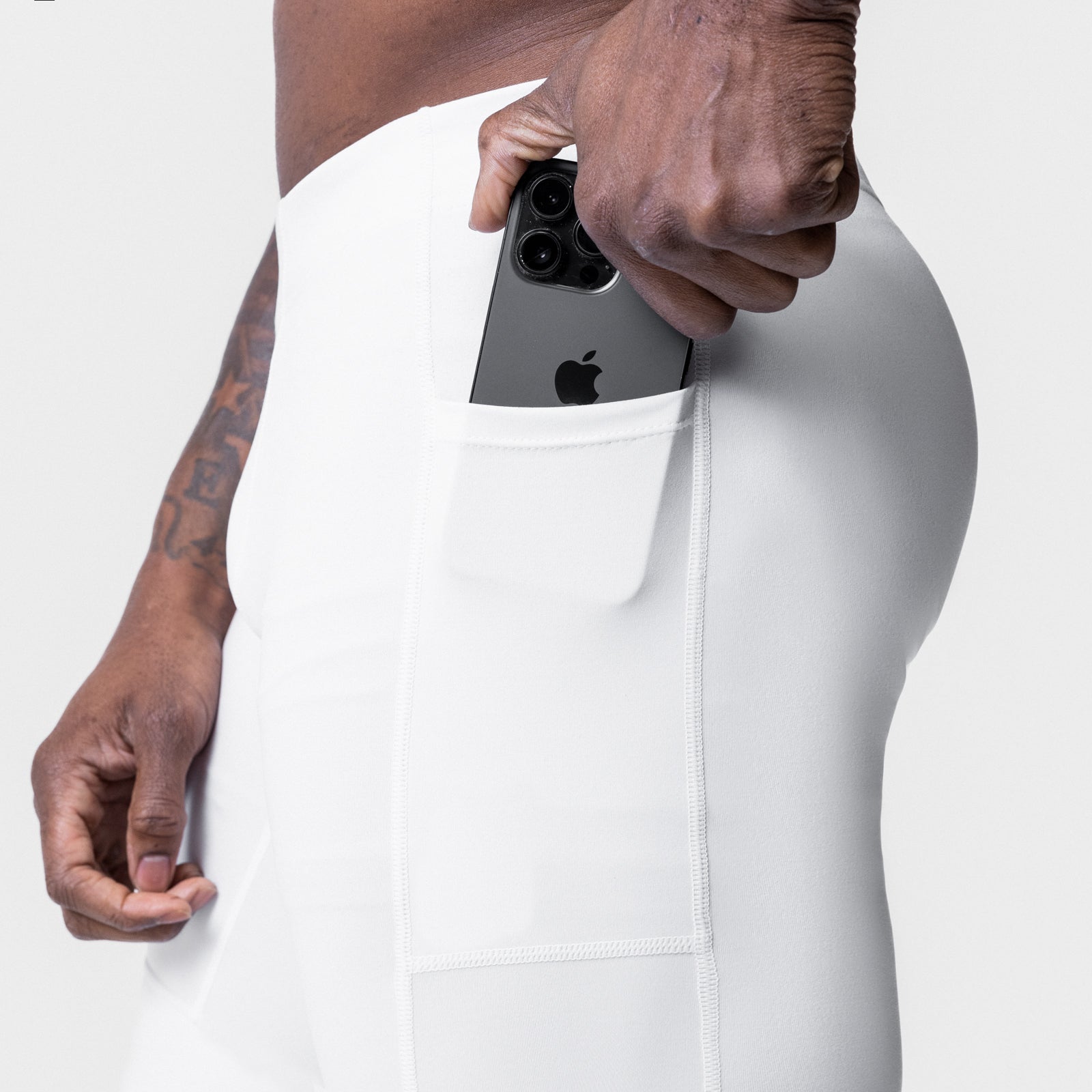 WarpFlexx® Side Pocket 3/4-Length Legging in white, model holding phone in side pocket