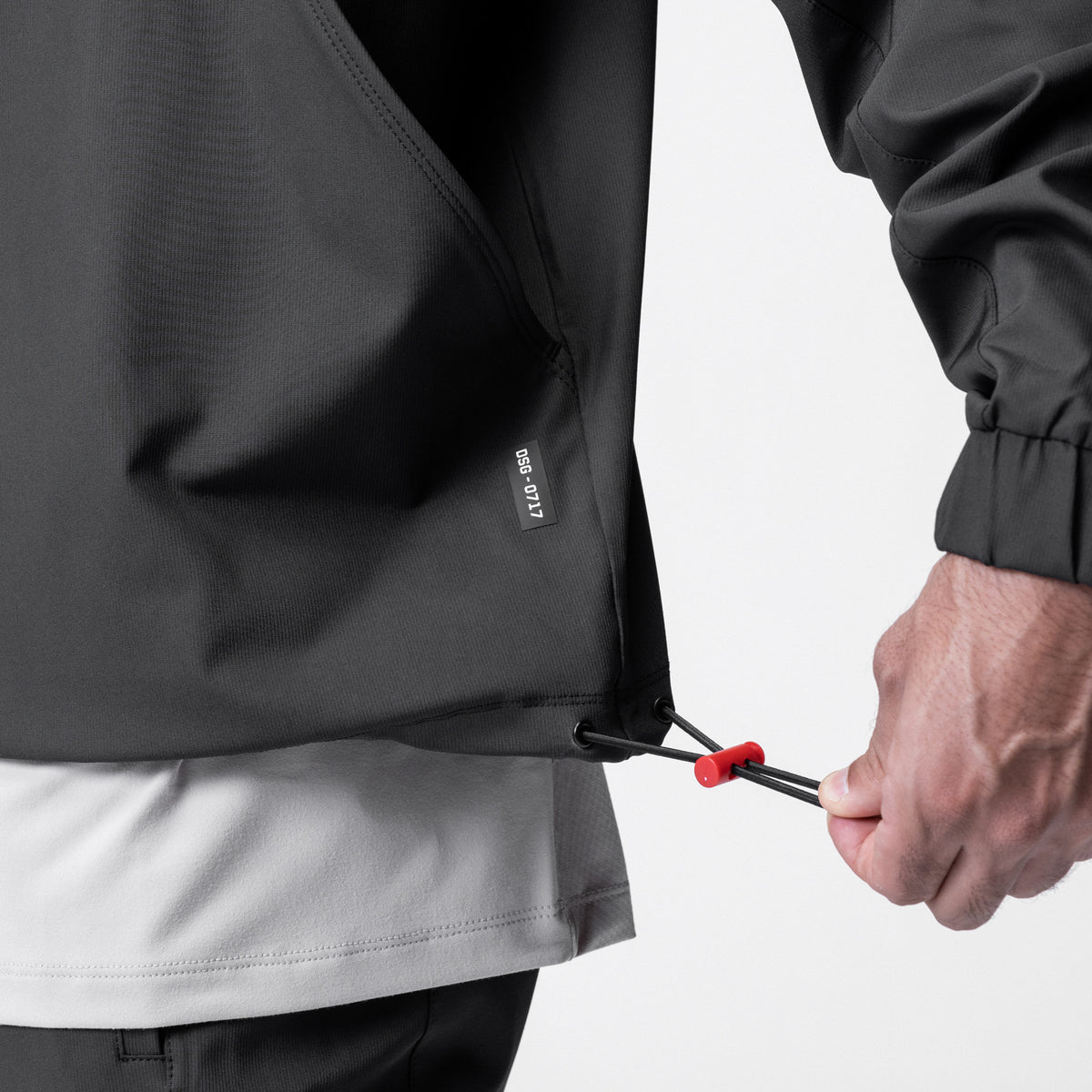 Weather-Ready Anorak Jacket in black, model holding drawstring detail