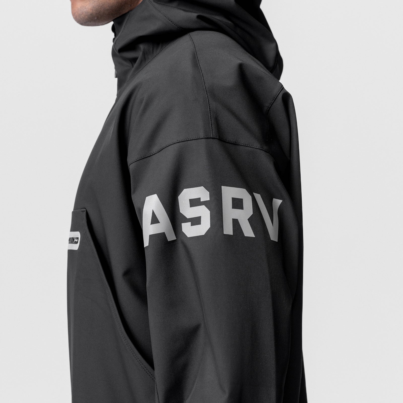 Black ASRV weather-ready anorak jacket worn by model, side view showing back logo