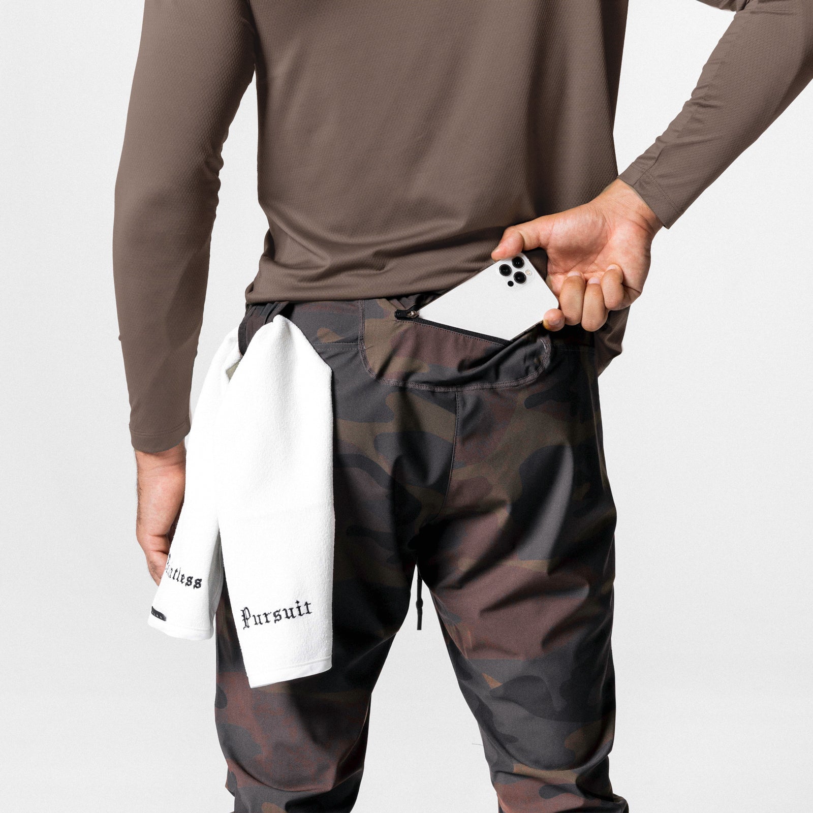 Tetra-Lite High Rib Jogger in rust camo worn by model, holding phone and white towel