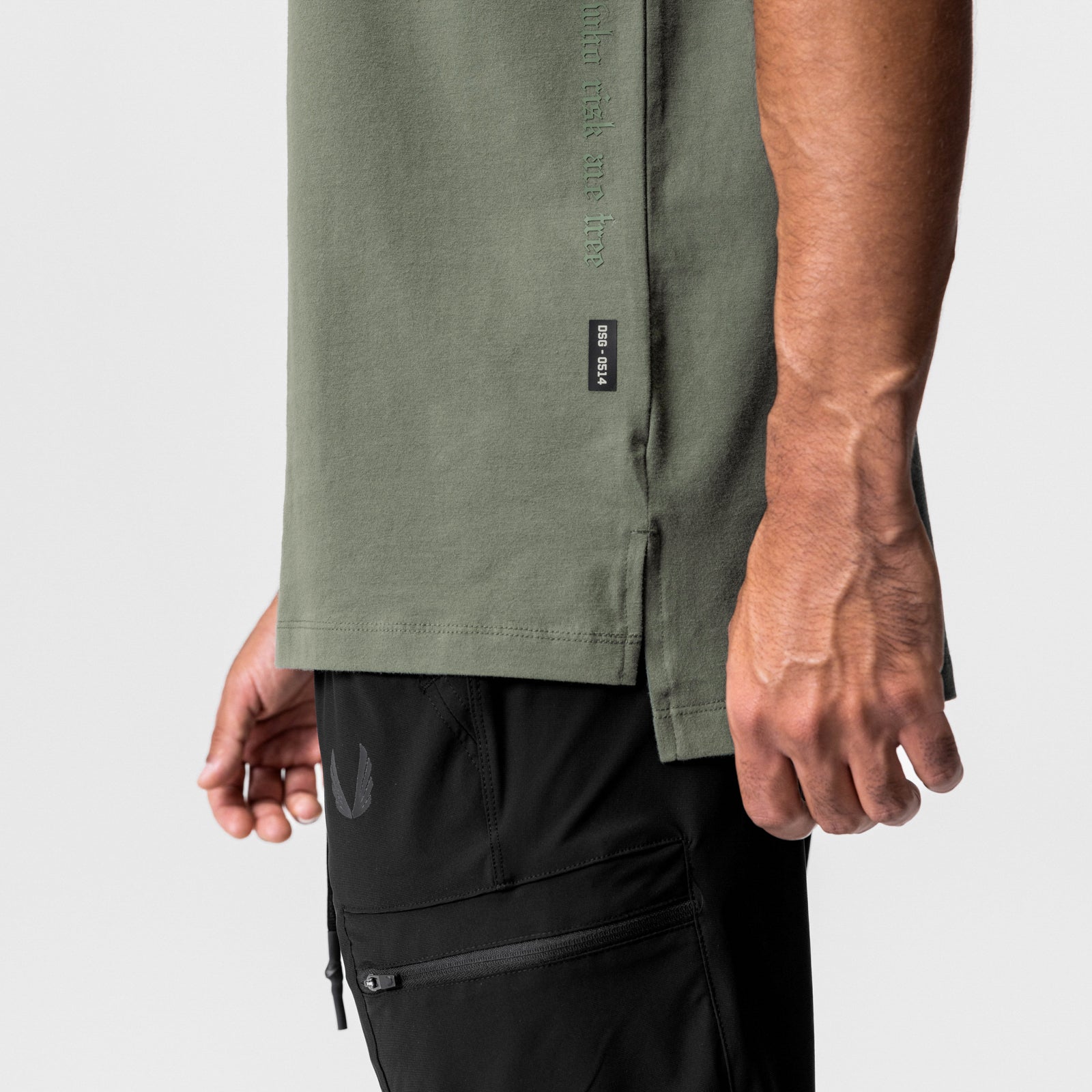 CottonPlus Oversized Tee in olive worn by model with black cargo shorts, side view