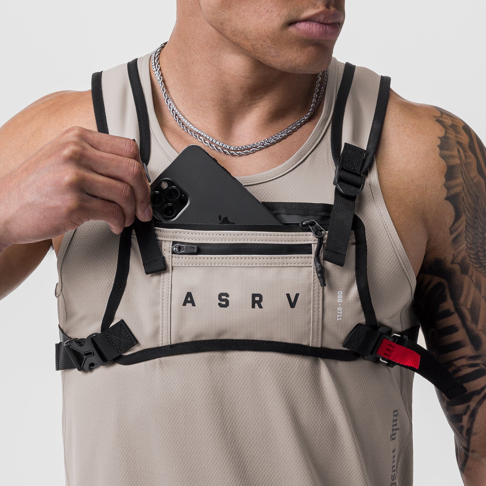 0711 Cordura Lightweight Chest Pack in Chai, worn by model holding phone