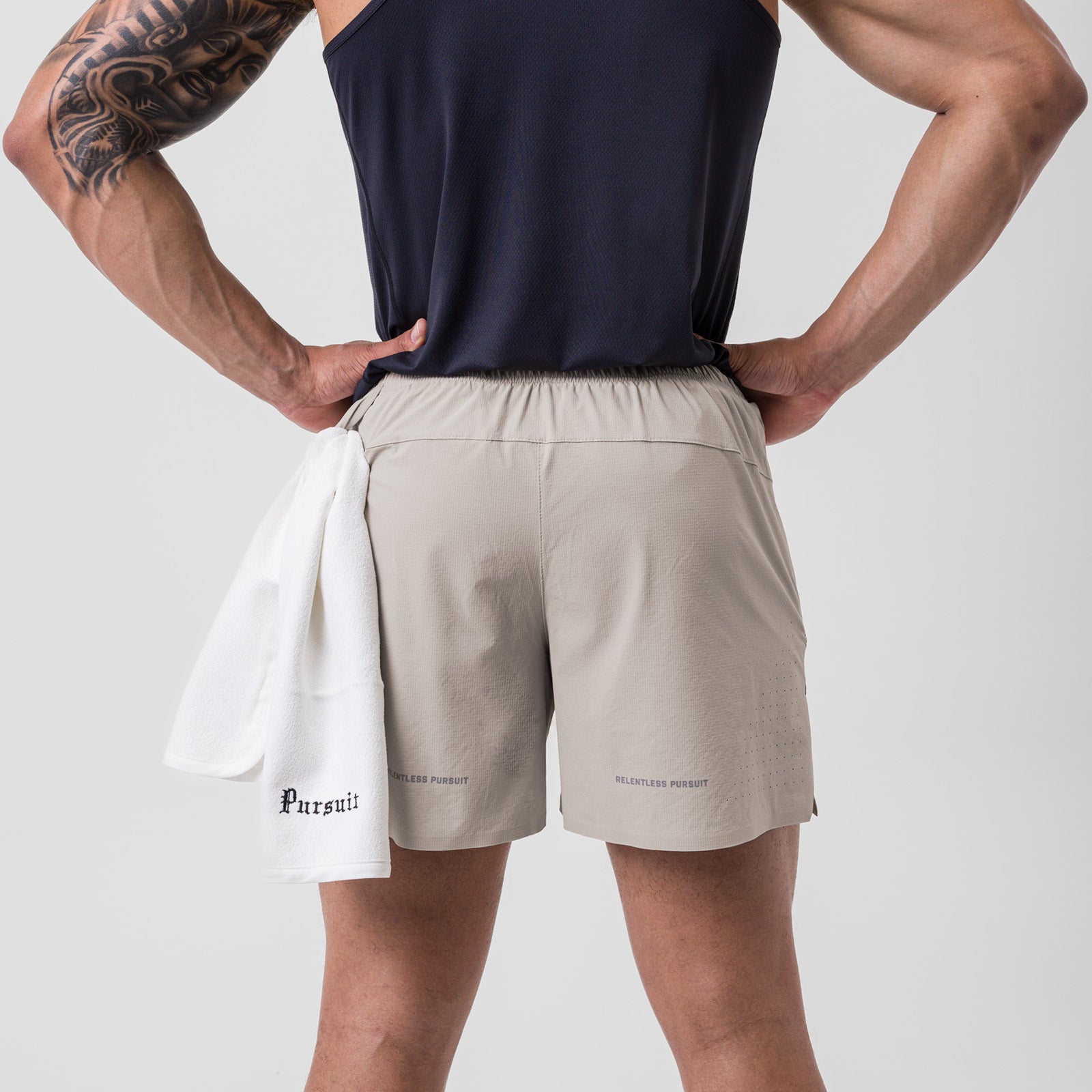 Ripstop 6" Perforated Short in Chai, worn by model with hands on hips, back view