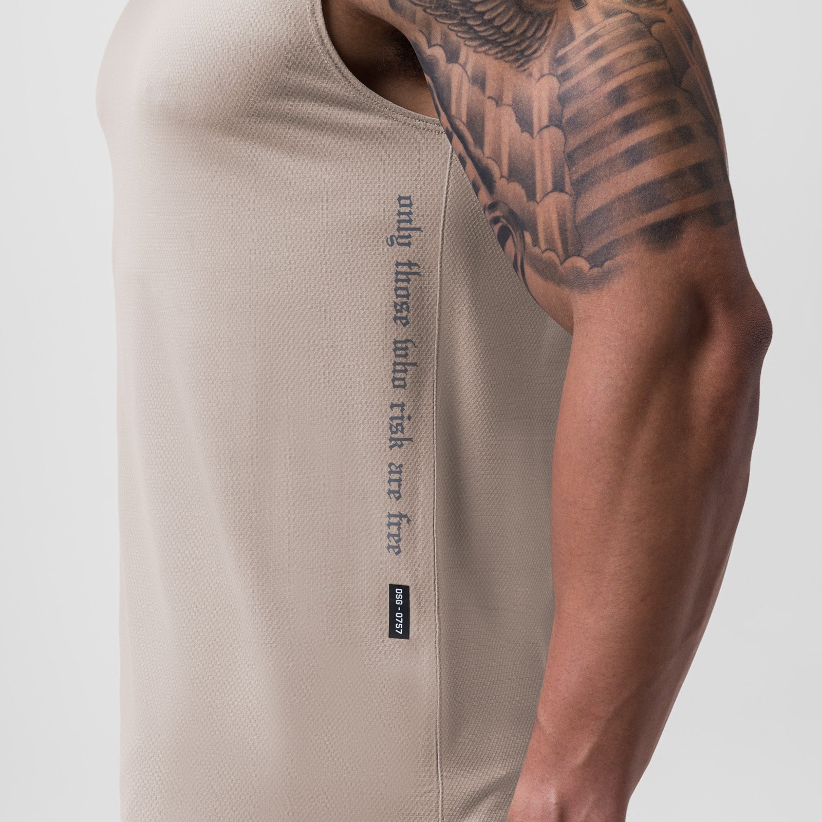AeroSilver® Cutoff Tank in Chai worn by model showing side view with wing tattoo visible