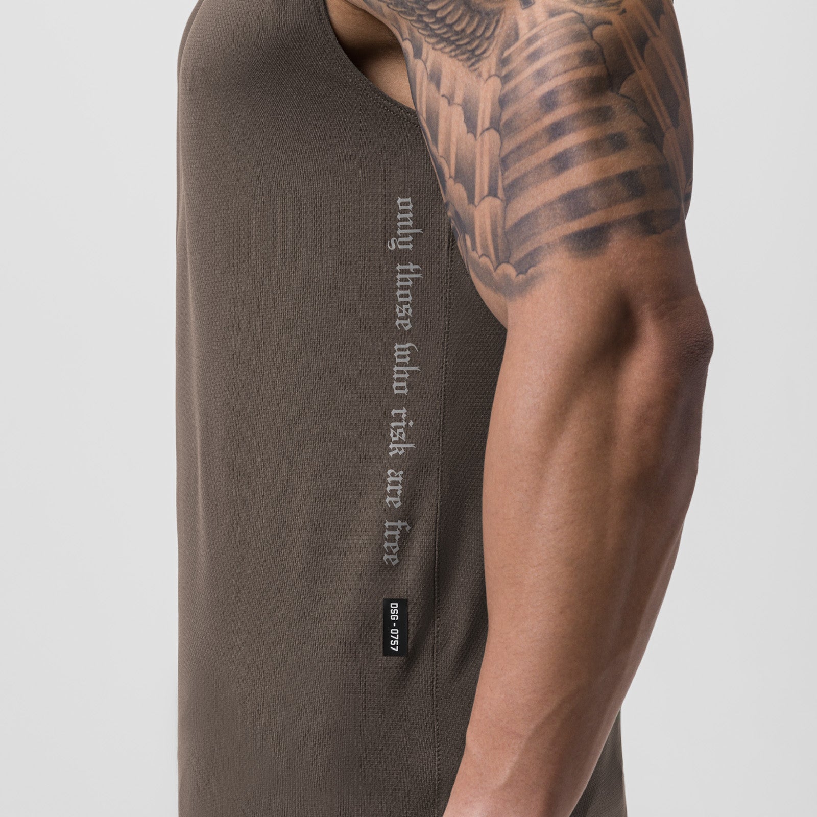 AeroSilver Cutoff Tank in deep taupe, worn by model showing side view with visible tattoo