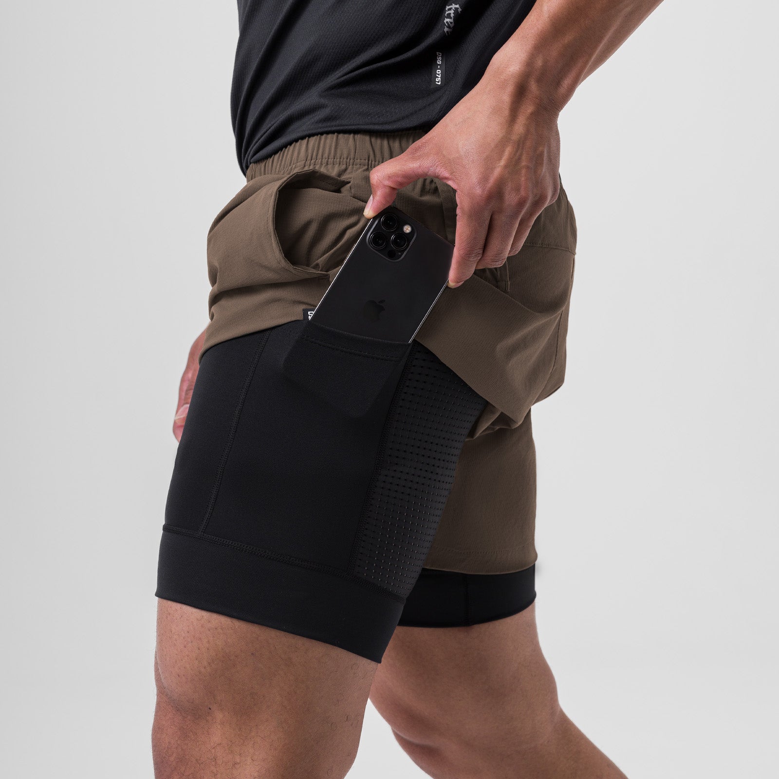 Ripstop 5" Liner Short in deep taupe, worn with black undershorts, model holding phone in pocket