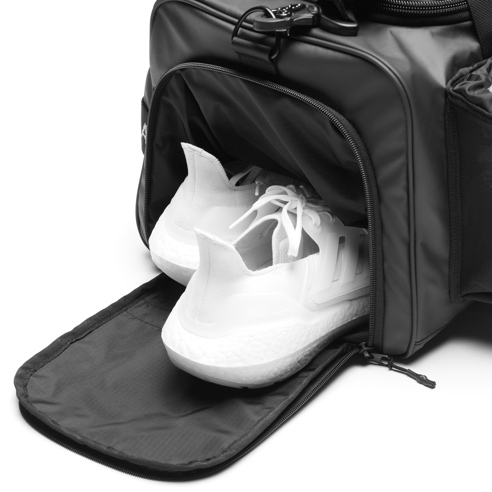 Flatlay Waterproof 2-in-1 Travel Duffle in black with shoe compartment open