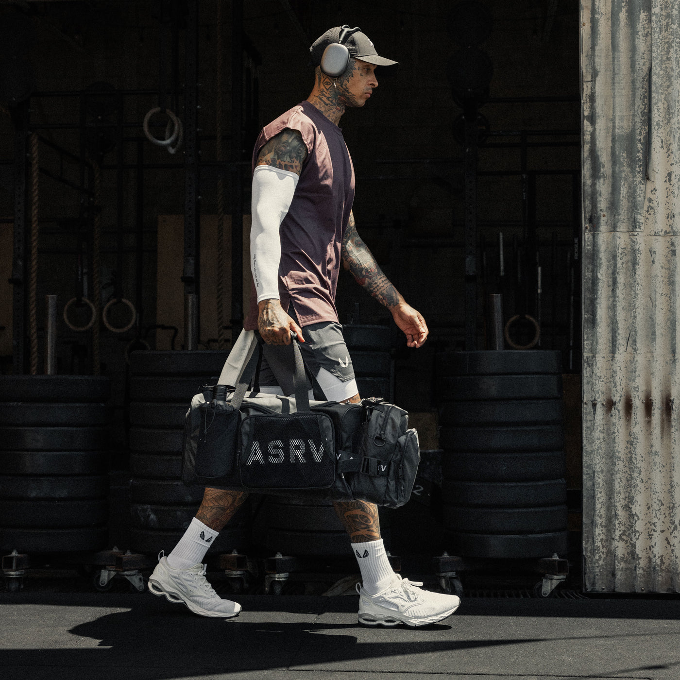 Waterproof 2-in-1 Travel Duffle in black, carried by model in athletic wear