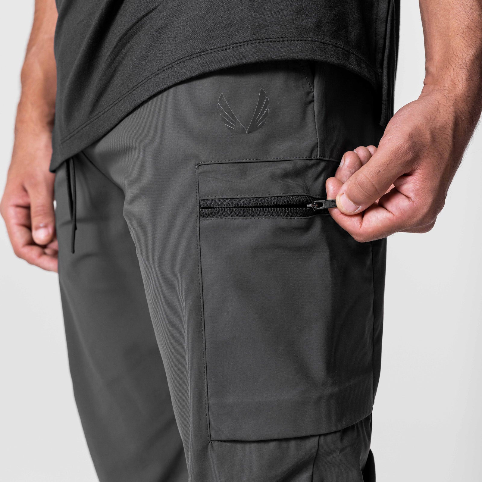 Tetra-Lite Standard Zip Jogger in Space Grey, model wearing joggers with hand on zippered pocket