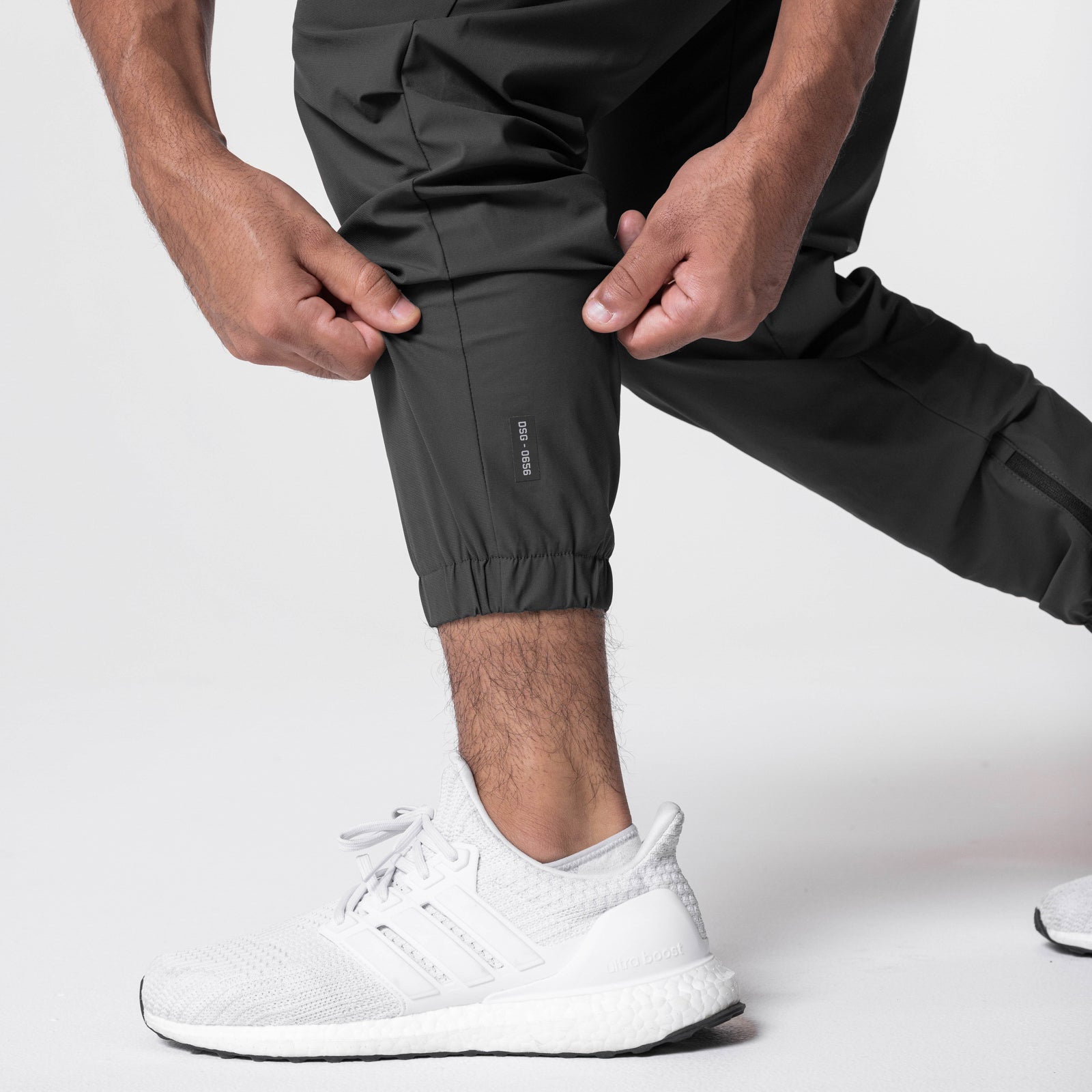 Tetra-Lite Standard Zip Jogger in Space Grey, worn with white sneakers, cropped view