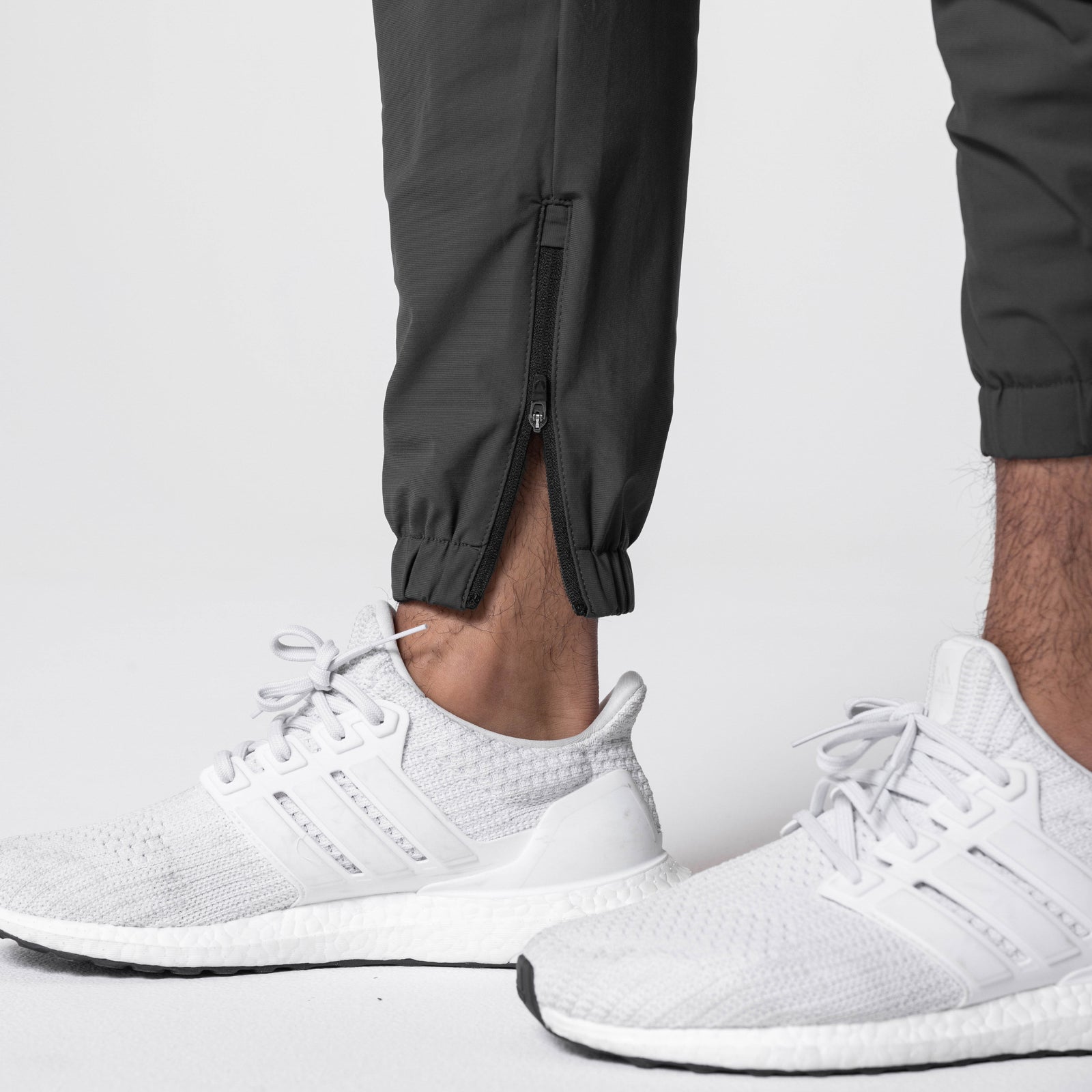 Tetra-Lite Standard Zip Jogger in black worn with white sneakers, ankle detail view