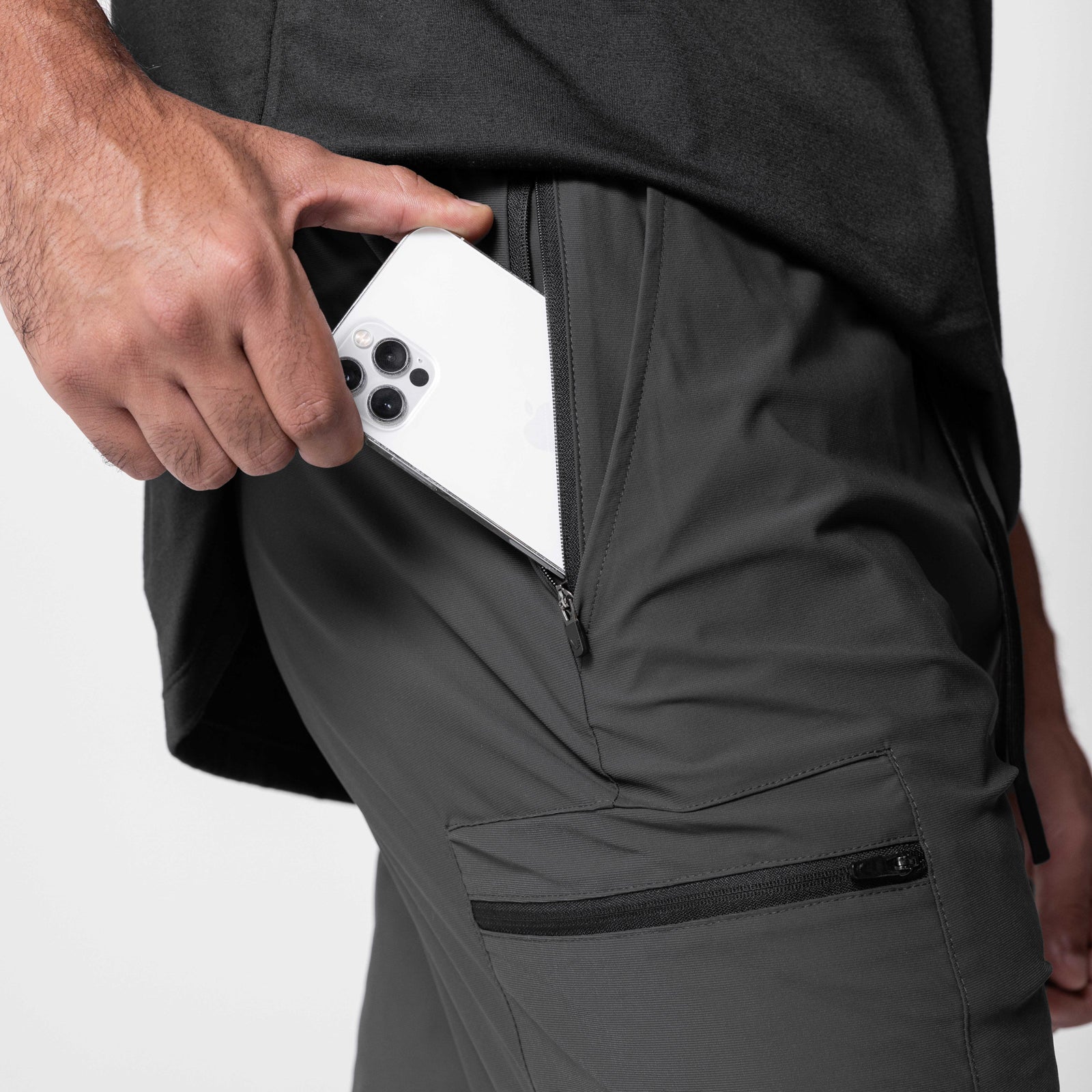 Tetra-Lite Standard Zip Jogger in Space Grey, model holding white phone in pocket