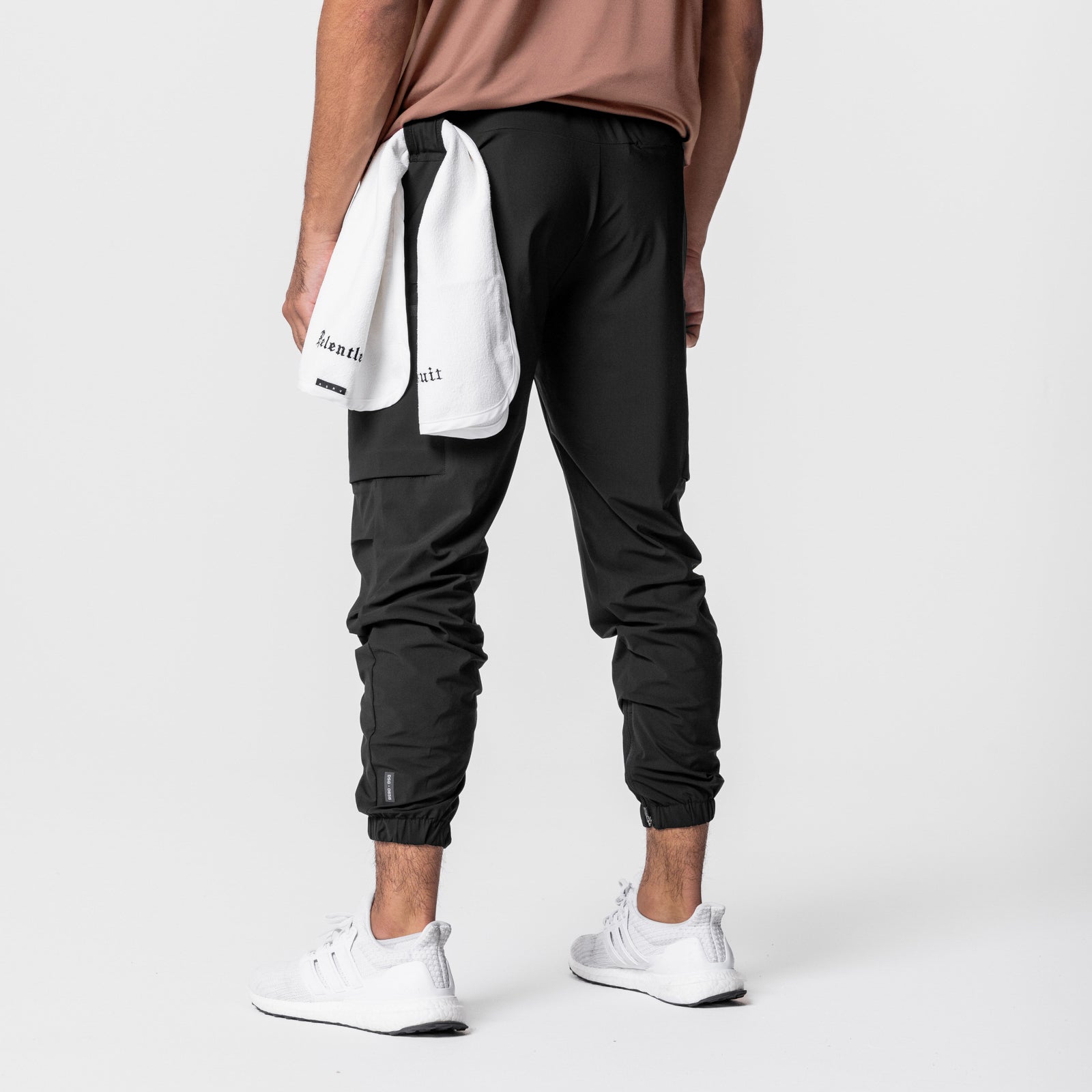 Black Tetra-Lite Standard Zip Jogger worn by model, rear view with white towel