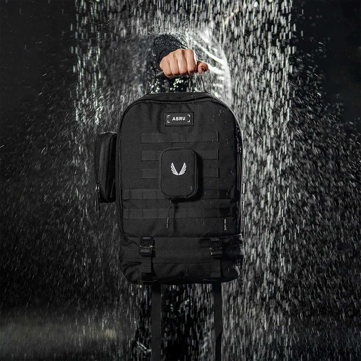 0275 Modular Everyday Pack in black, worn by person in rain