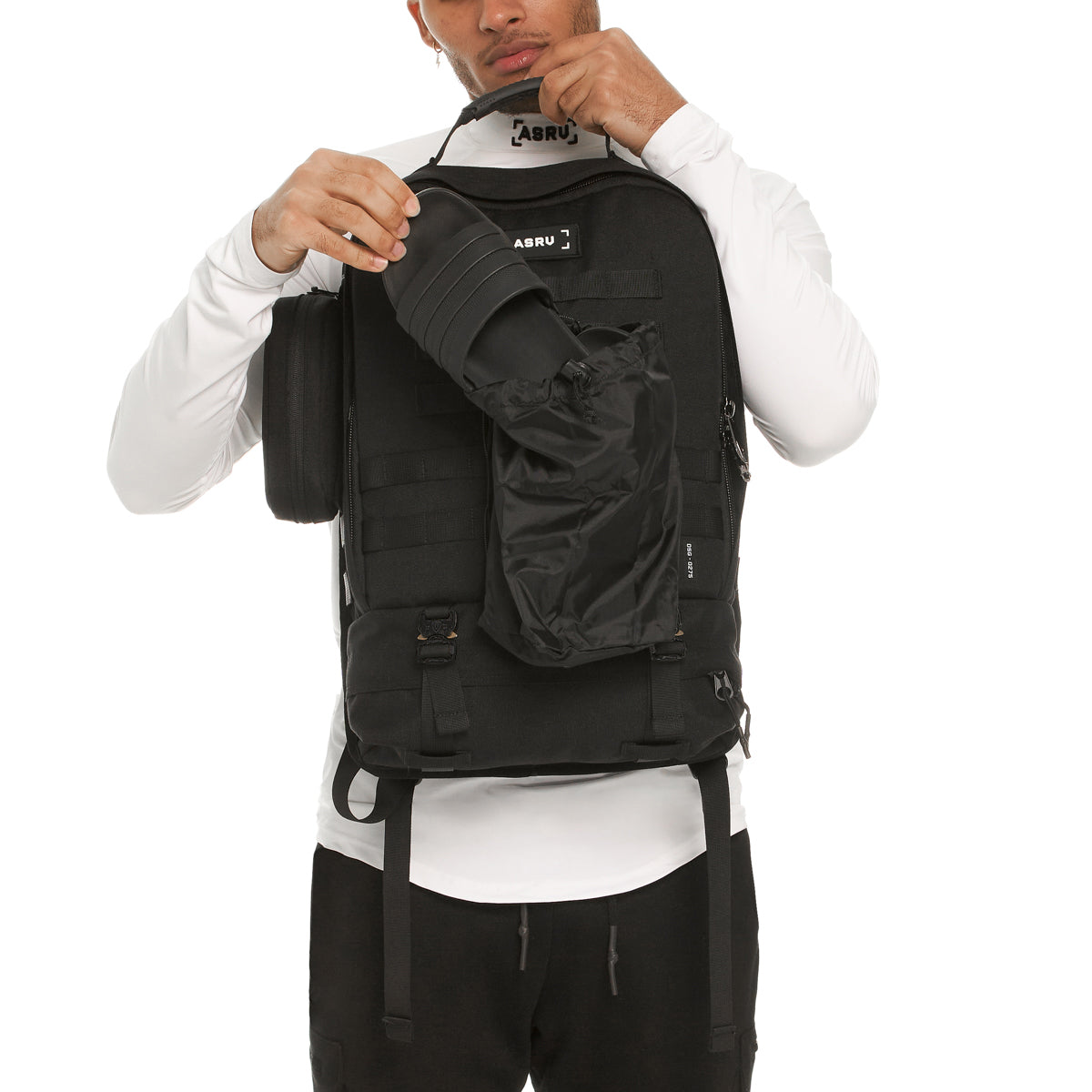 0275 Modular Everyday Pack in black, worn by model showing front pocket detail