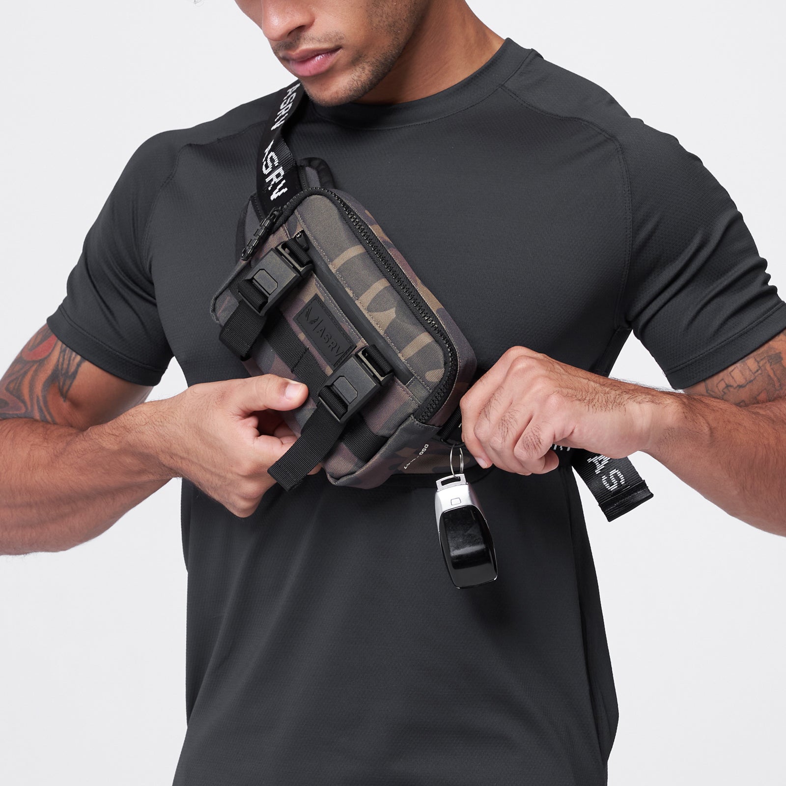 Small Crossbody Bag in Rust Camo, worn and held by male model