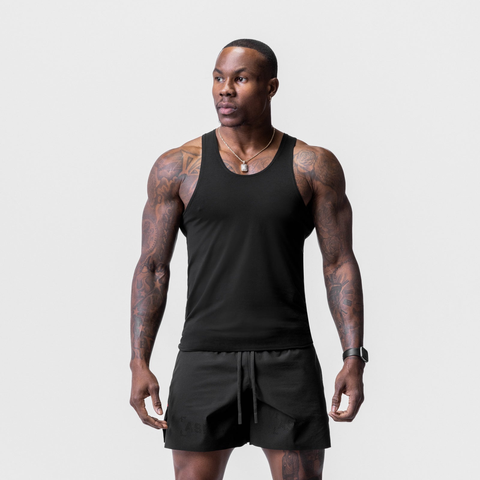 Black Solucell™ Essential Slim Tank worn by male model with matching black shorts, front view
