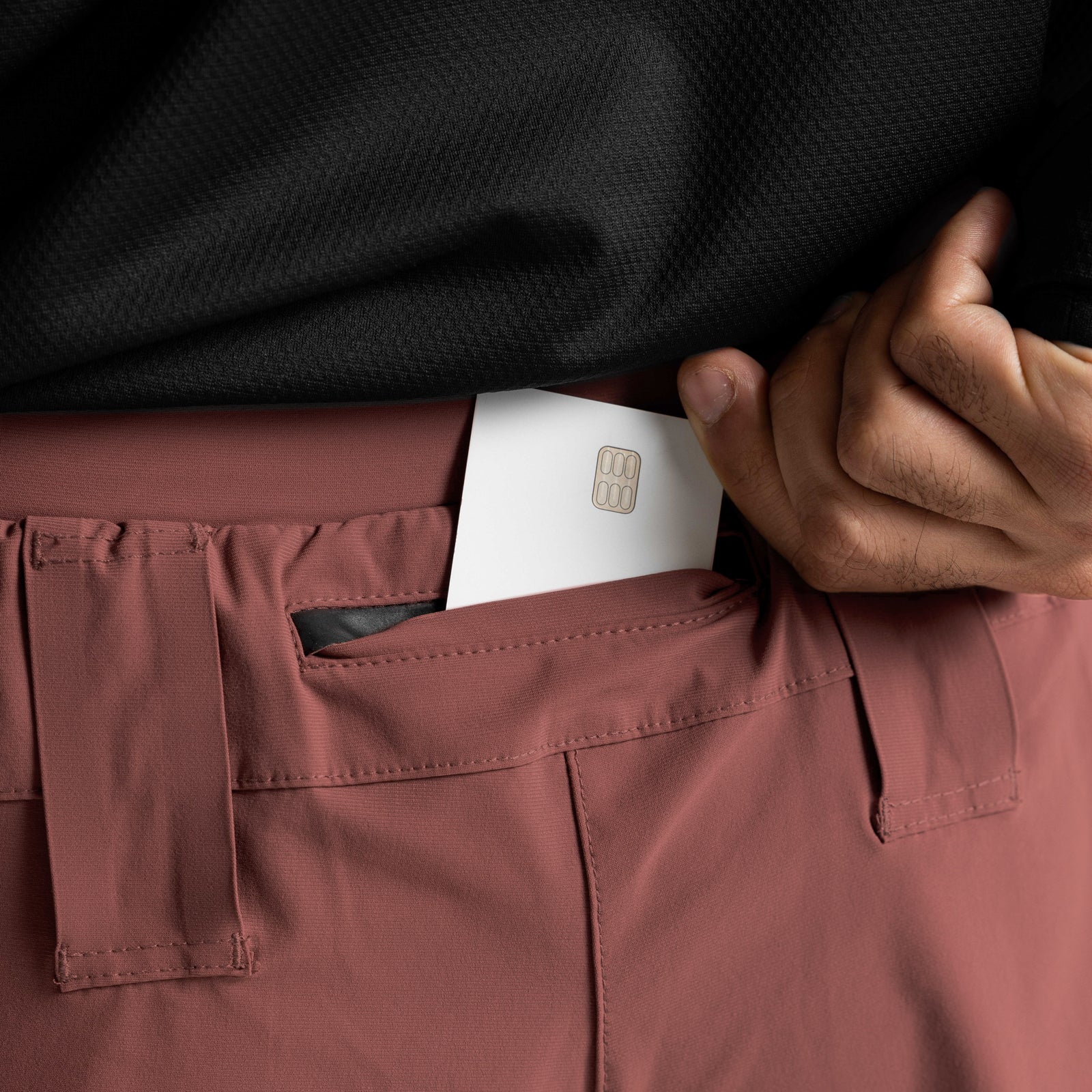 Tetra-Lite Laser Cut 3" Short in Canyon Rose, model holding detail shot showing pocket and card