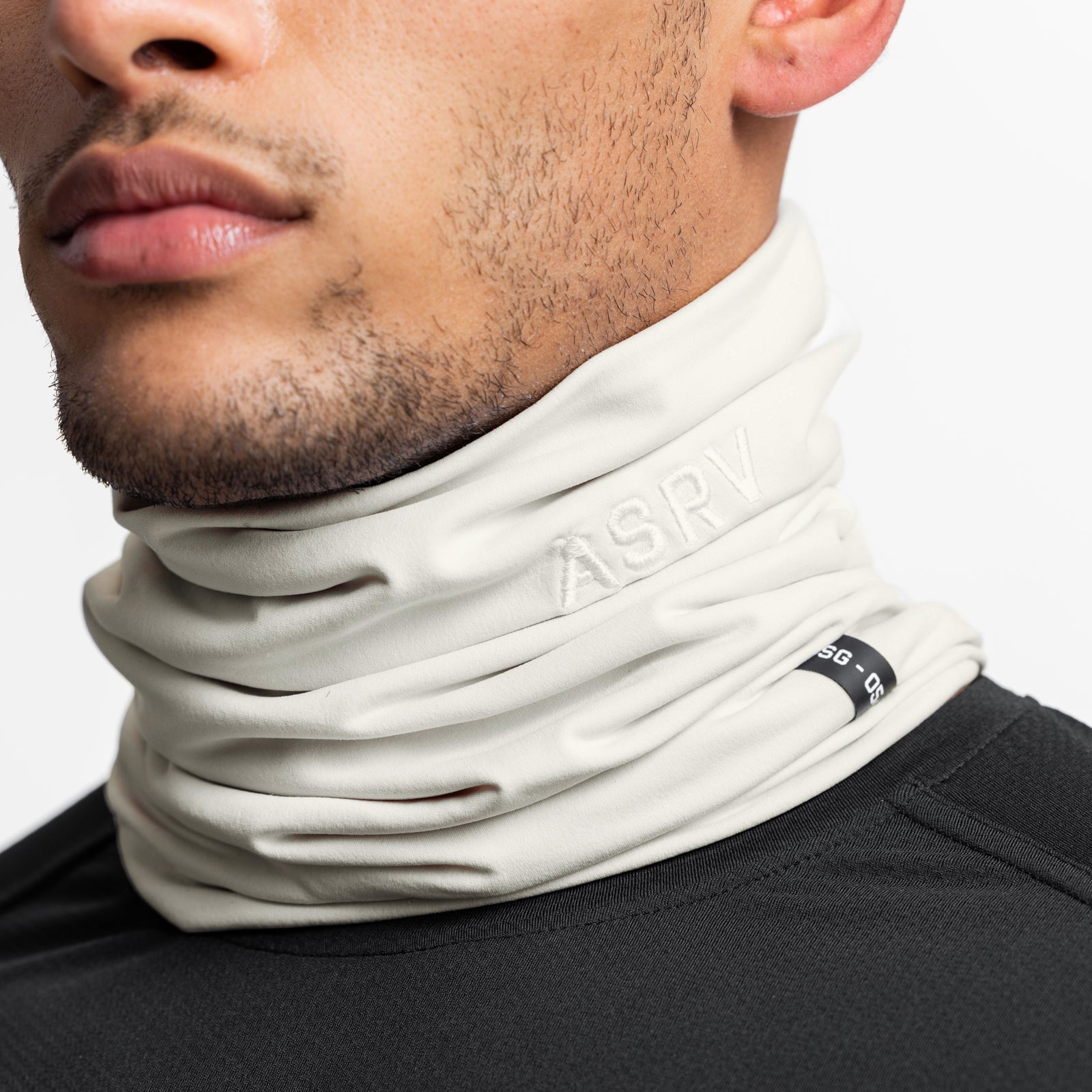 Thermal Gaiter in ivory cream worn around model's neck, side profile view