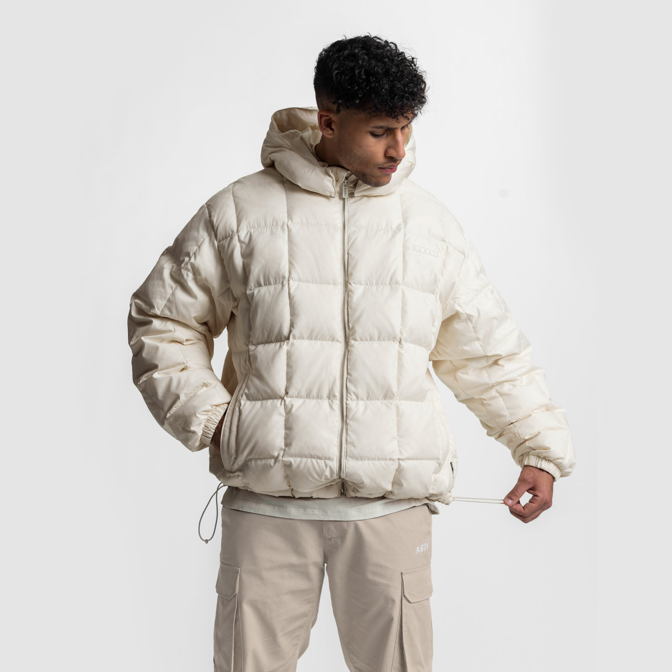 Weather-Ready Down Puffer Jacket in ivory cream worn by model with matching cargo pants