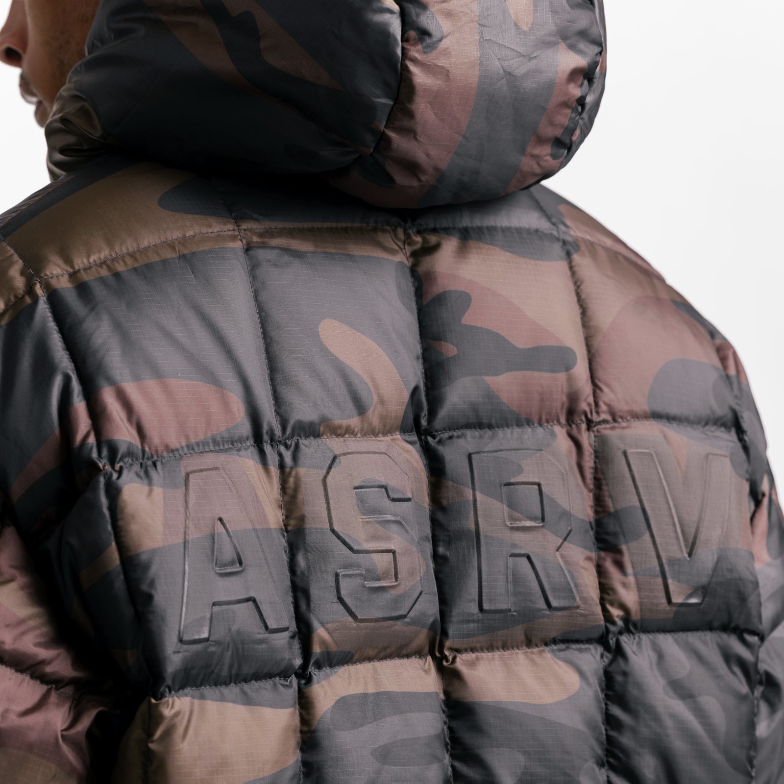 Weather-Ready Down Puffer Jacket in rust camo, worn by model showing back view with logo detail