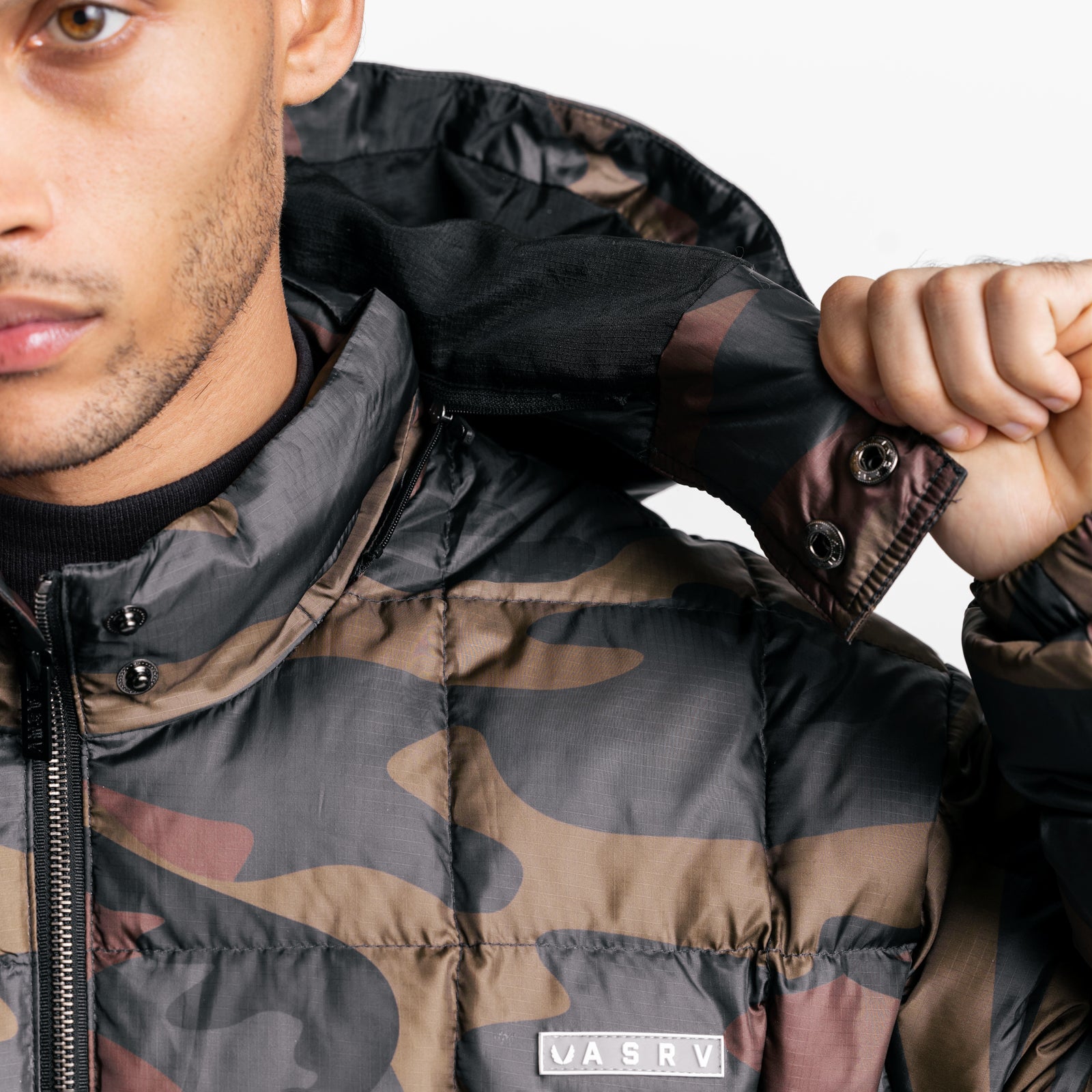 Weather-Ready Down Puffer Jacket in rust camo worn by model, front view with hood detail