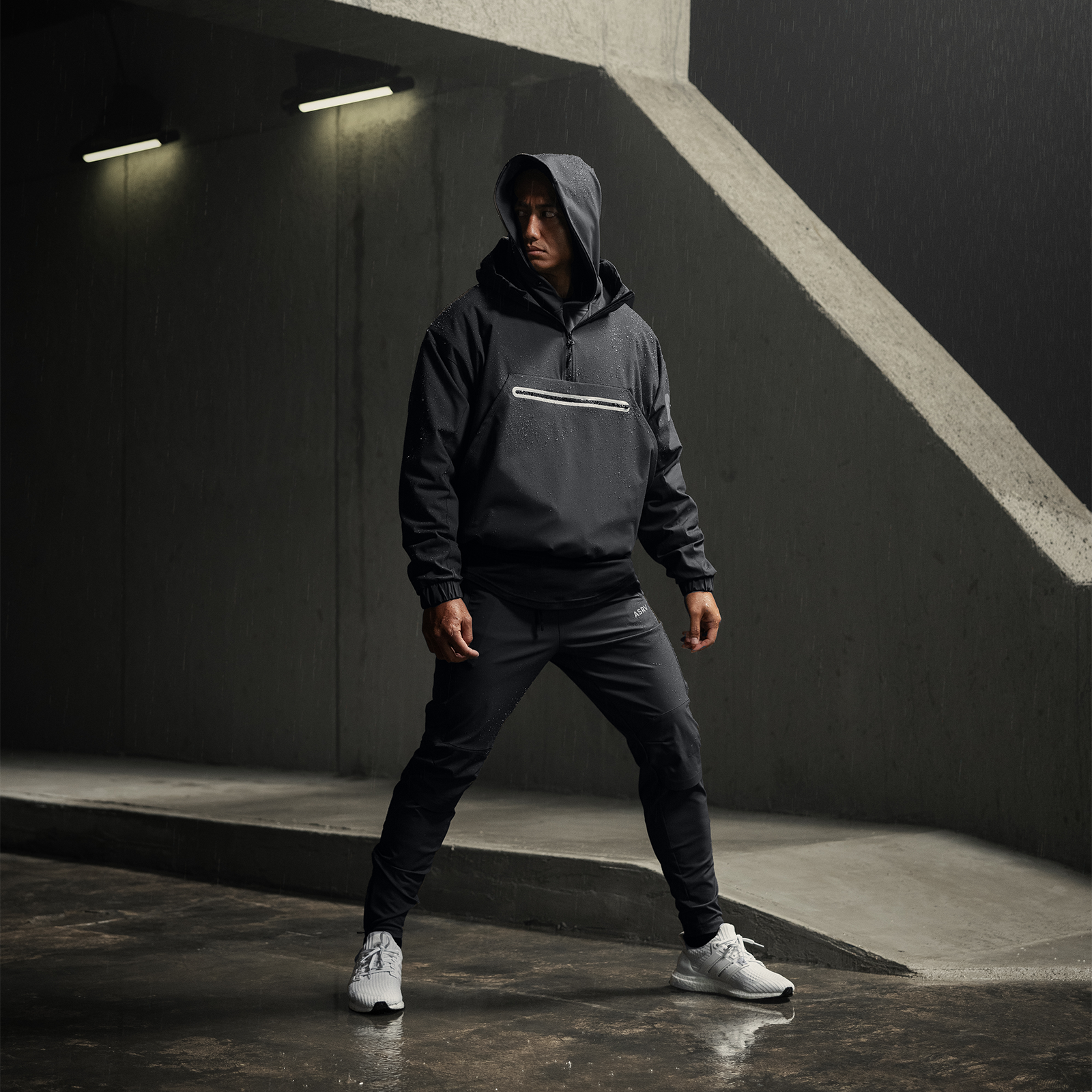 Weather-Ready Anorak Jacket in black worn by model in urban concrete setting