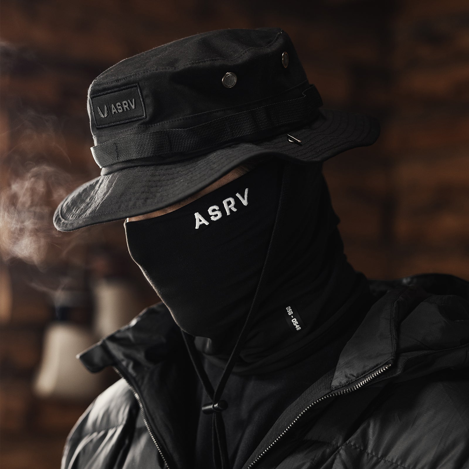 Vented Boonie Hat in black, worn with neck gaiter and puffer jacket