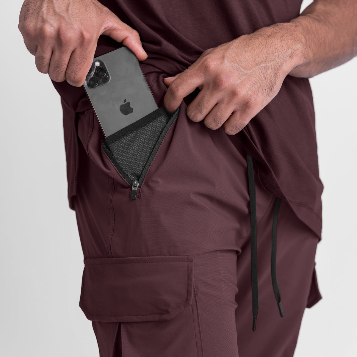Tetra-Lite Cargo High Rib Jogger in Faded Plum, model holding phone in cargo pocket
