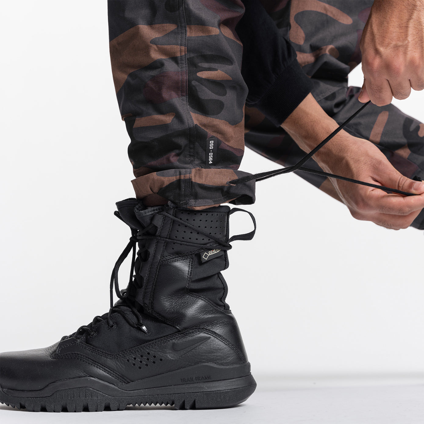 Weather-Ready Technical Cargo Pant in Rust Camo worn with black boots, detail view
