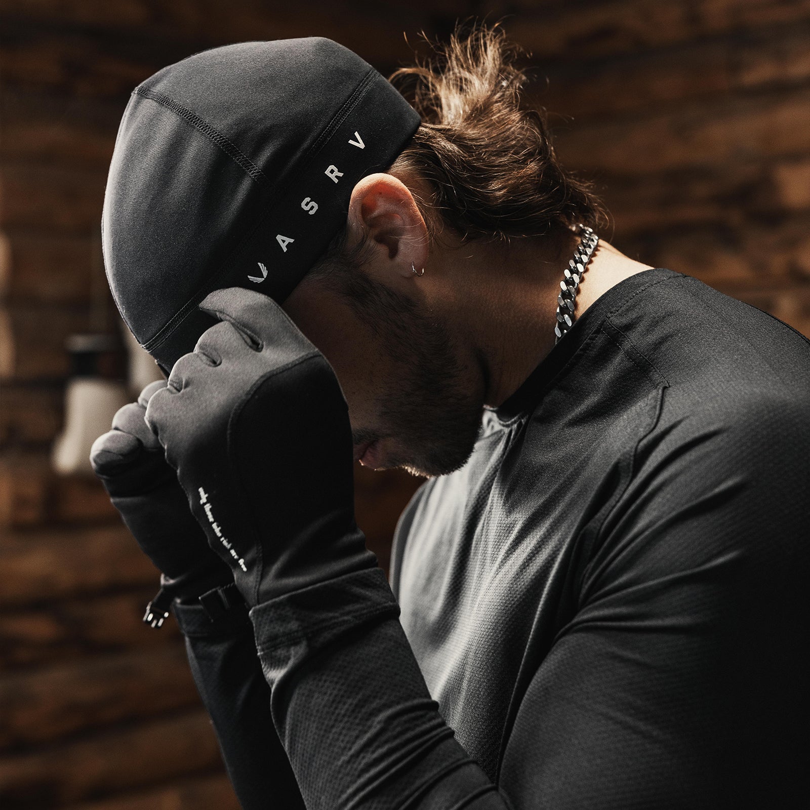 Performance Wings Logo Skull Cap in black, worn by model in side profile pose